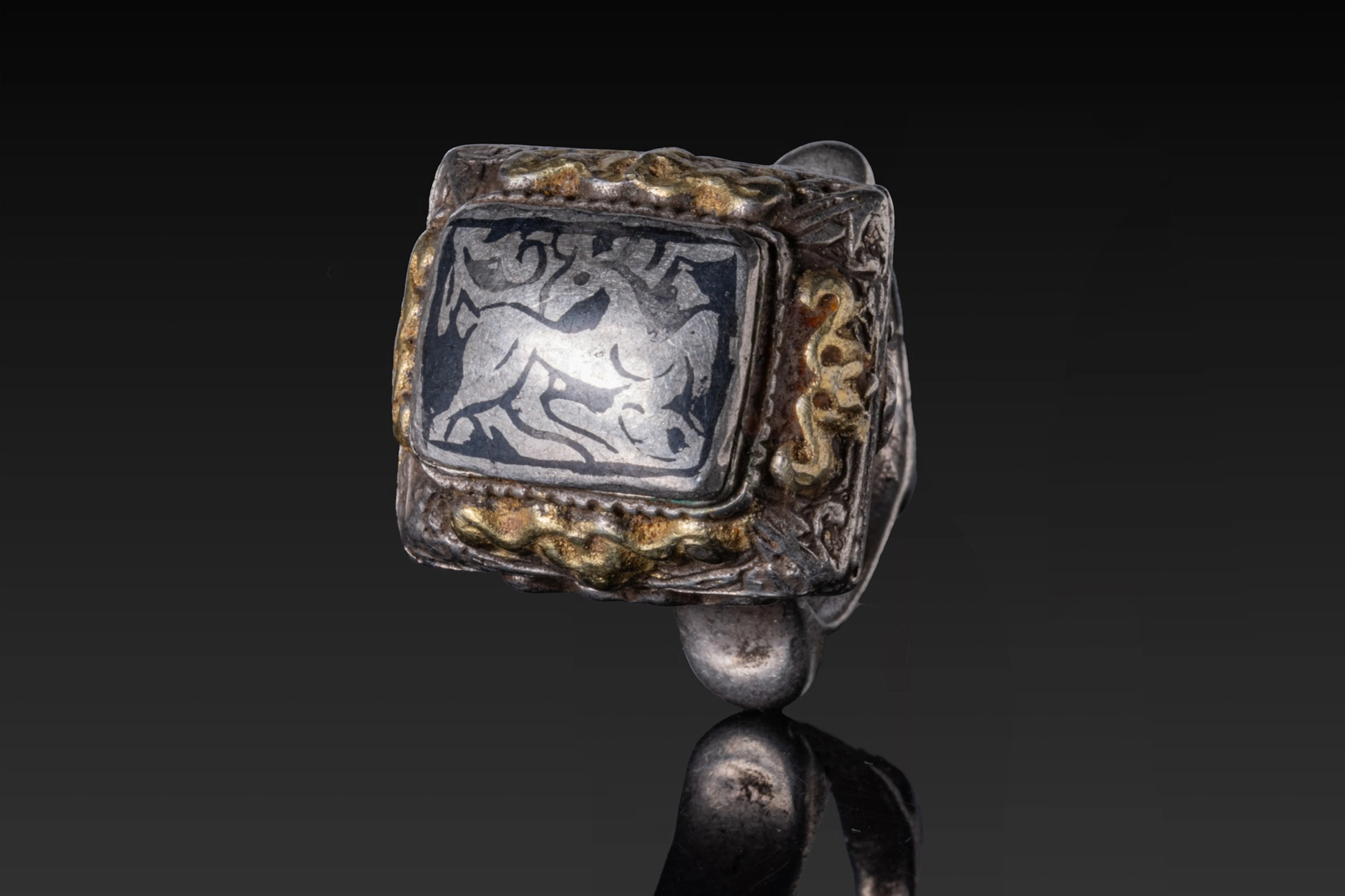 SELJUK SILVER AND NIELLO RING WITH DEER AND FLORAL MOTIF