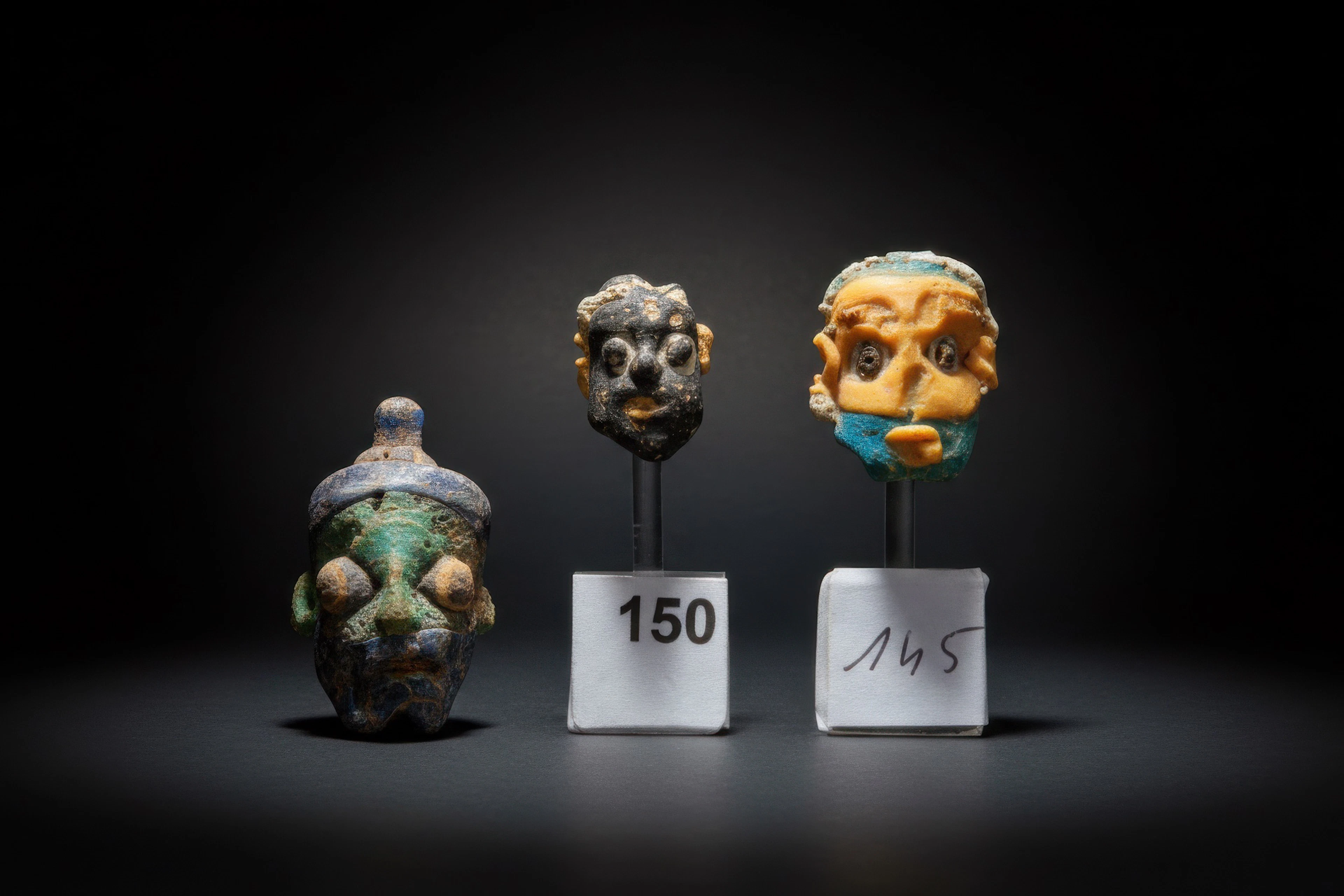 COLLECTION OF PHOENICIAN GLASS HEAD BEADS