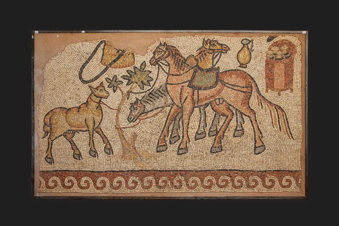 LATE ROMAN MOSAIC PANEL WITH HORSES AND GEOMETRIC FRAME MOTIF