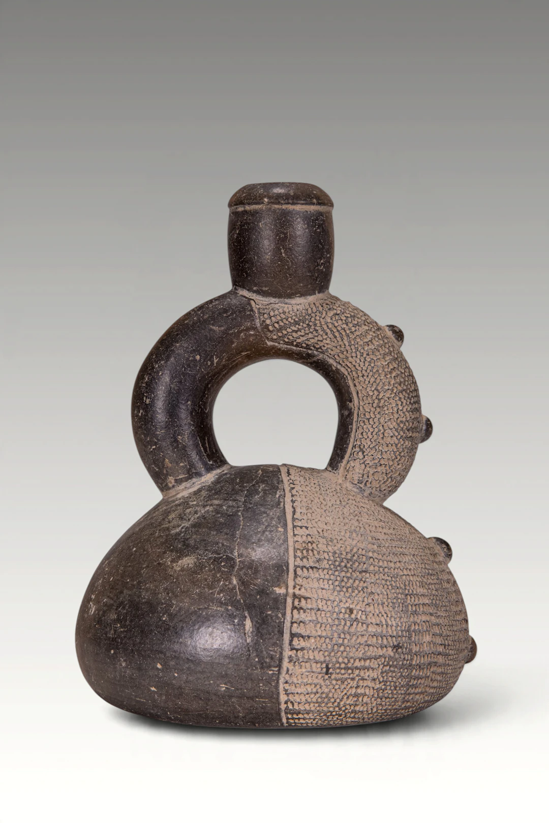 PRE-COLUMBIAN CUPISNIQUE CERAMIC STIRRUP-SPOUT VESSEL