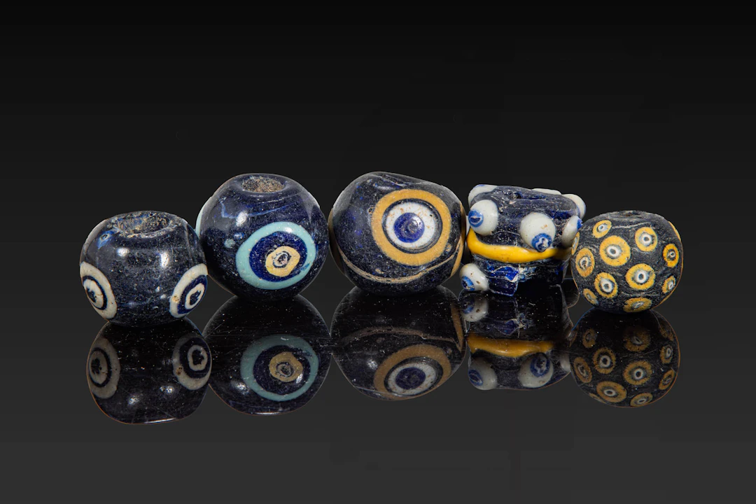 COLLECTION OF LARGE PHOENICIAN POLYCHROME GLASS EYE BEADS