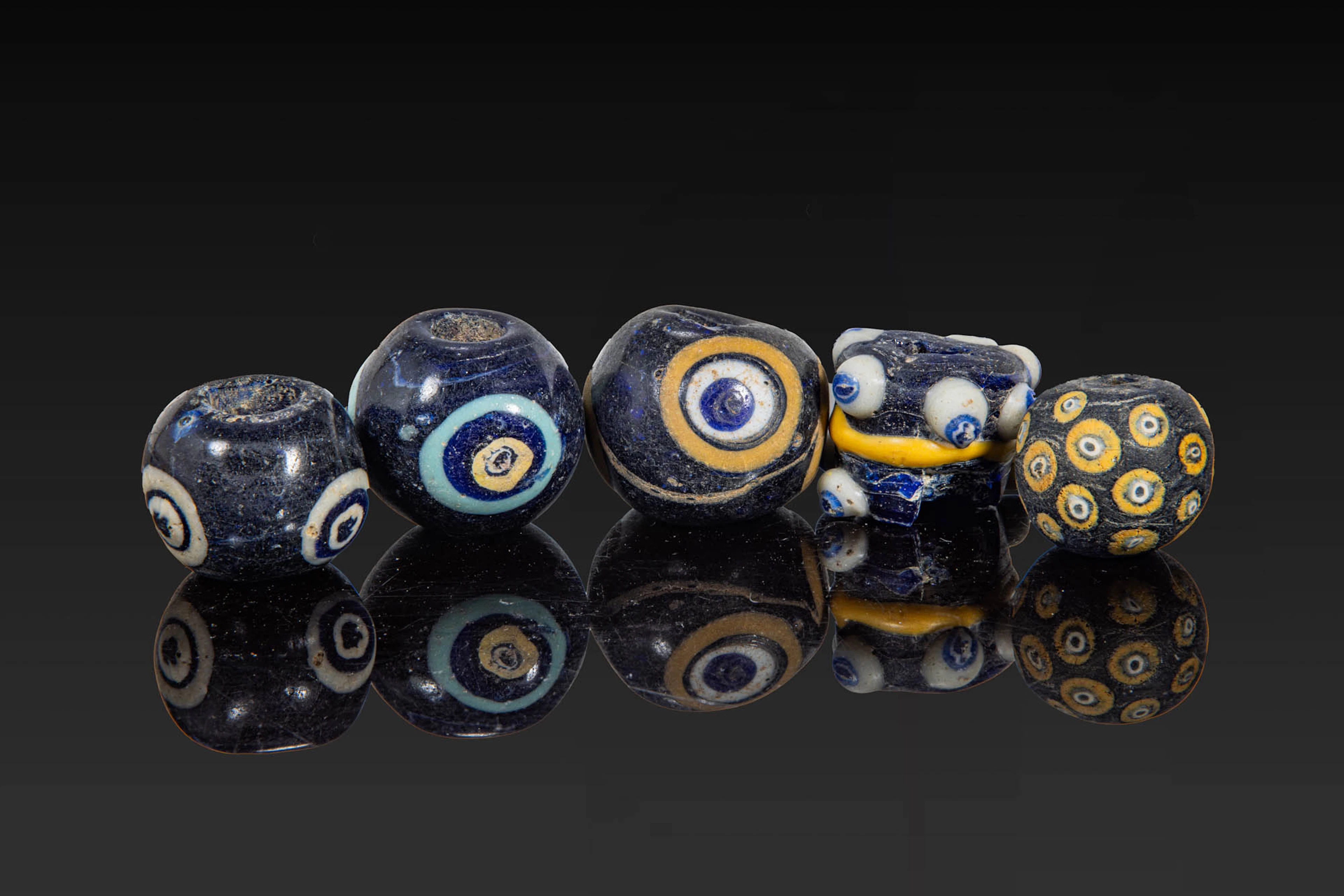 COLLECTION OF LARGE PHOENICIAN POLYCHROME GLASS EYE BEADS