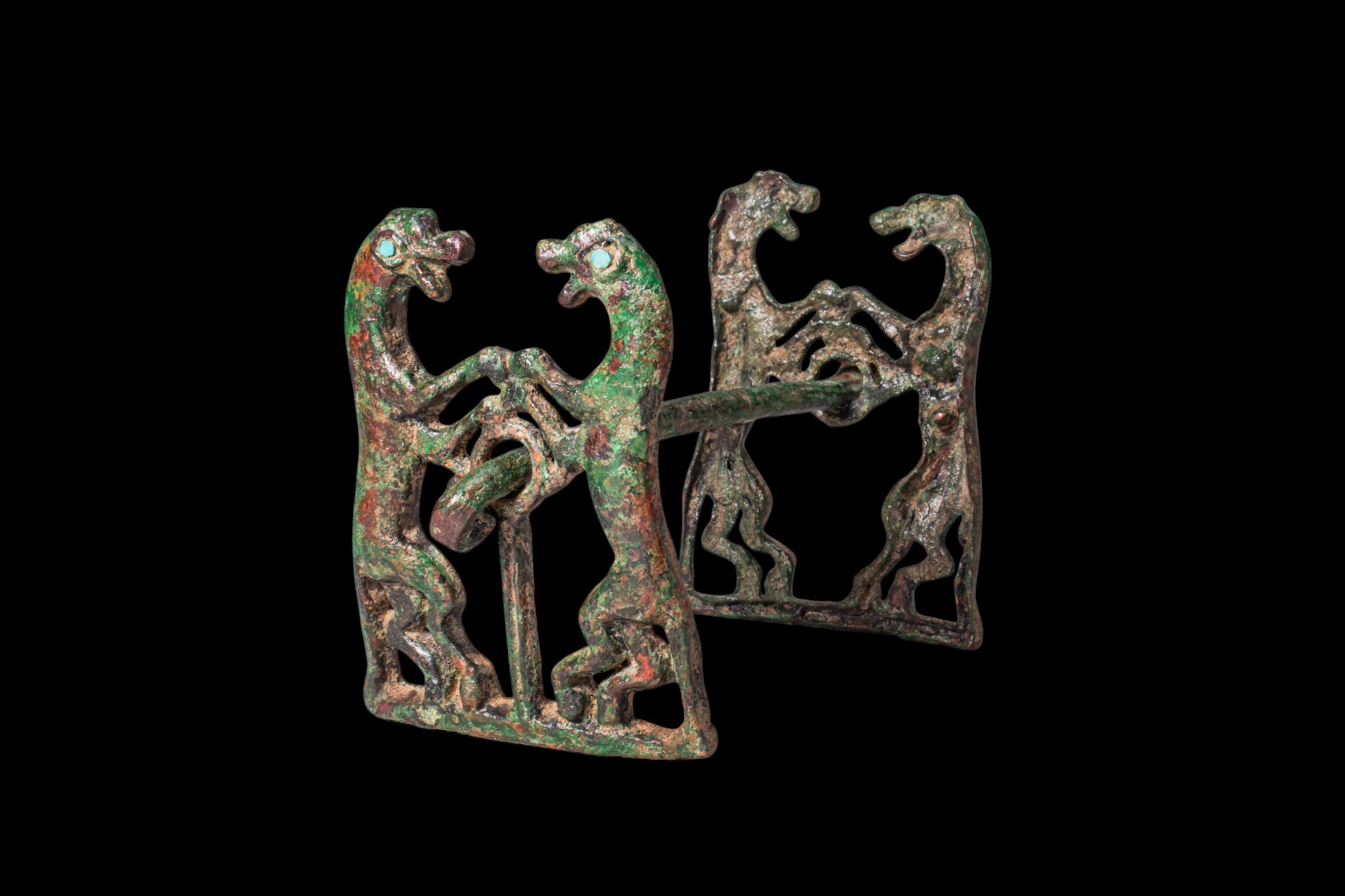 BRONZE AGE HORSE BIT WITH RAMPANT FELINE CHEEK PIECES AND INLAID EYES