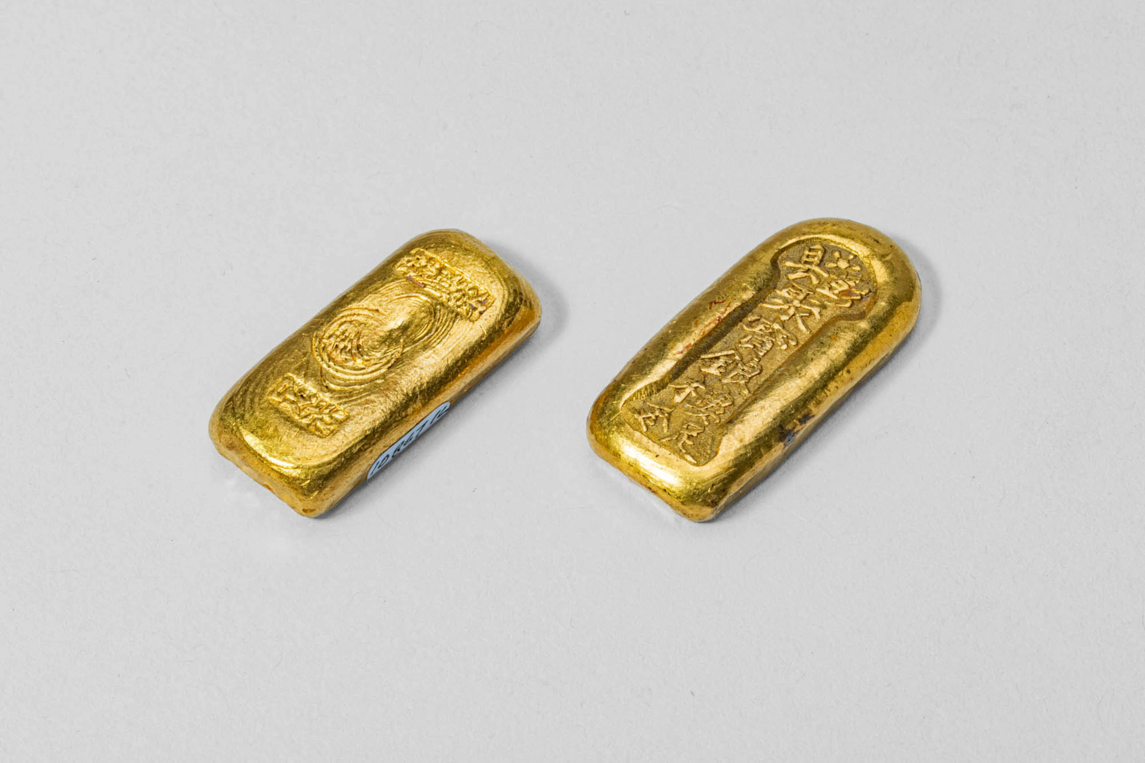 TWO CHINESE GOLD BAR-SHAPED INGOTS, 62.7 GRAMS