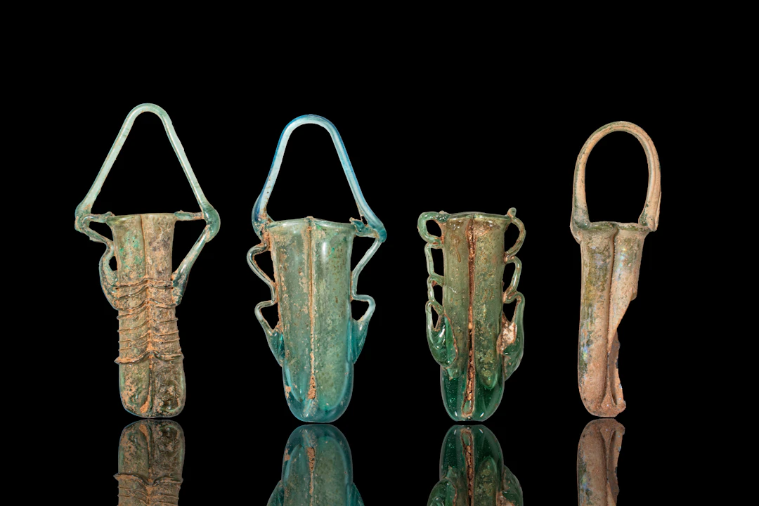 STUNNING COLLECTION OF LATE ROMAN GLASS DOUBLE UNGUENTARIA
