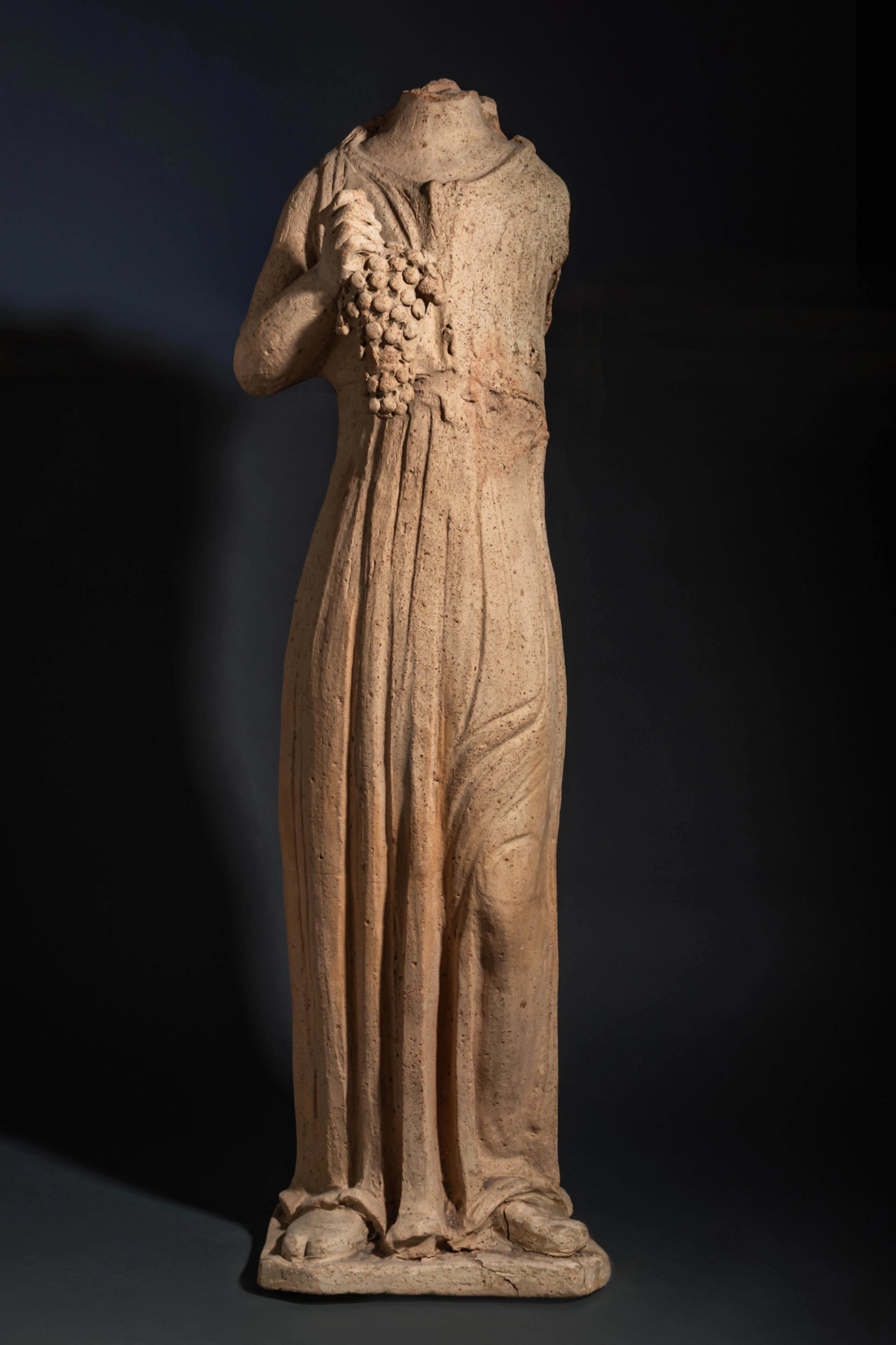 LIFE-SIZE ETRUSCAN TERRACOTTA STATUE OF FLORA HOLDING GRAPES