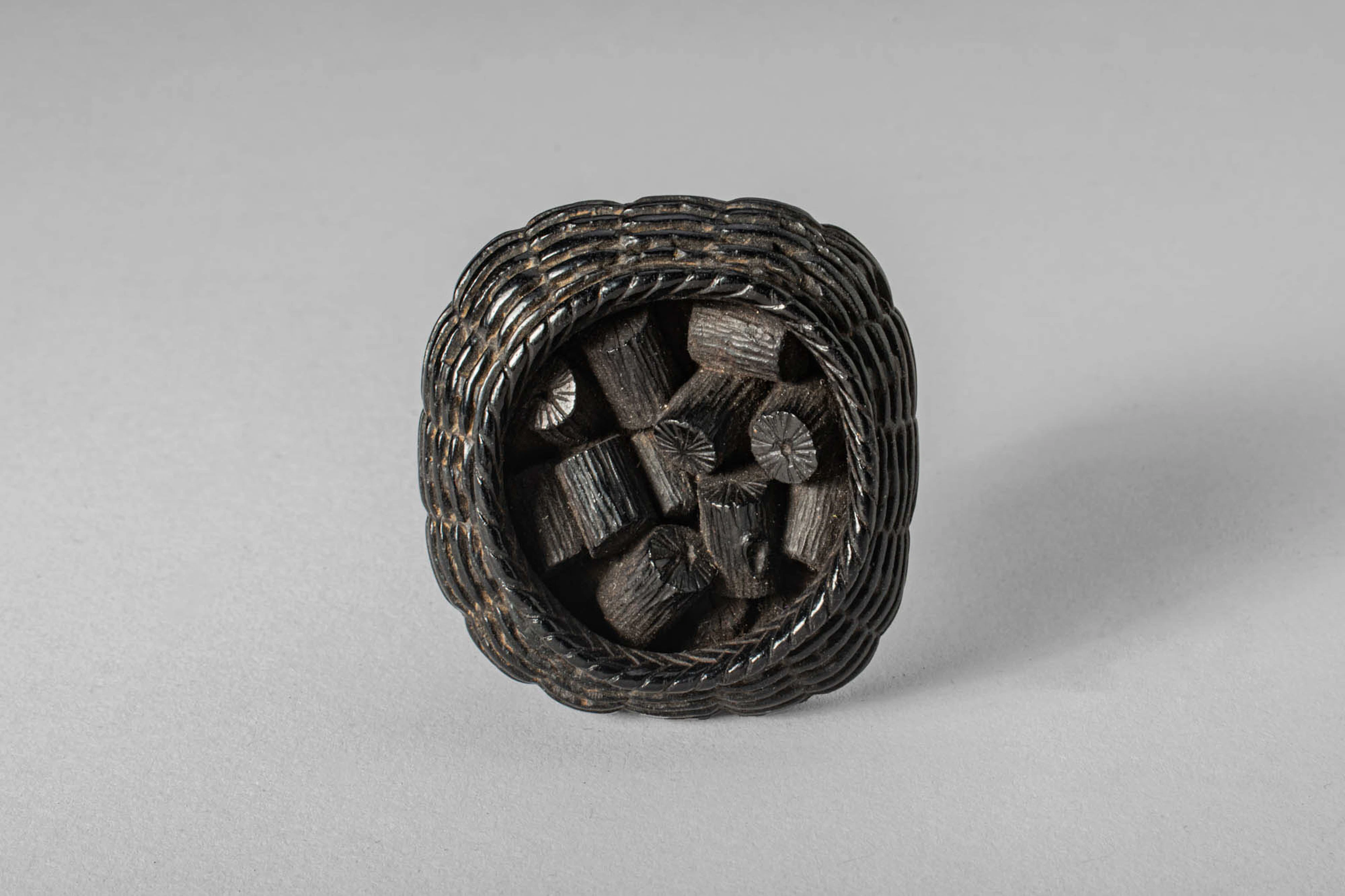 JAPANESE EBONY NETSUKE OF CHARCOAL, BY OUCHI GYOKUSO