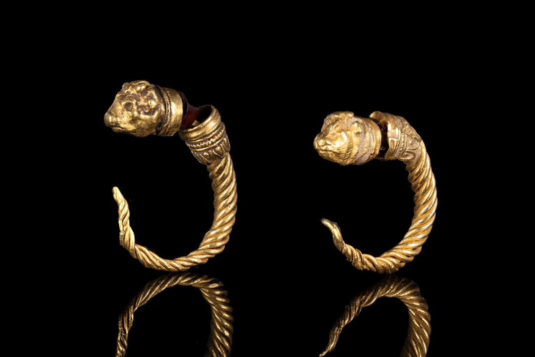 MATCHED PAIR OF GREEK TWISTED GOLD AND GARNET EARRINGS WITH BULL HEADS