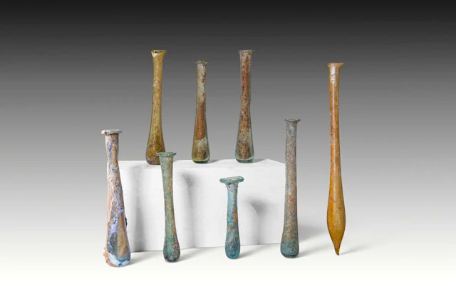 COLLECTION OF EIGHT ROMAN FUSIFORM GLASS UNGUENTARIA