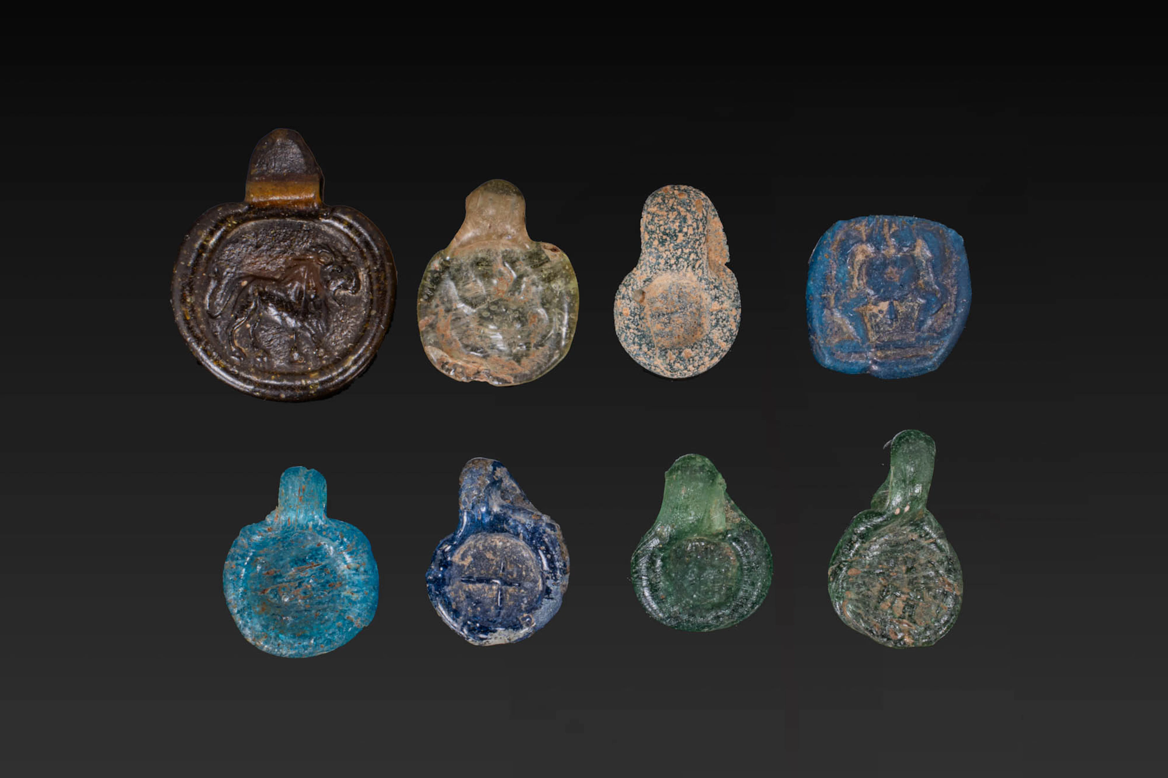 COLLECTION OF ROMAN GLASS STAMPED PENDANTS