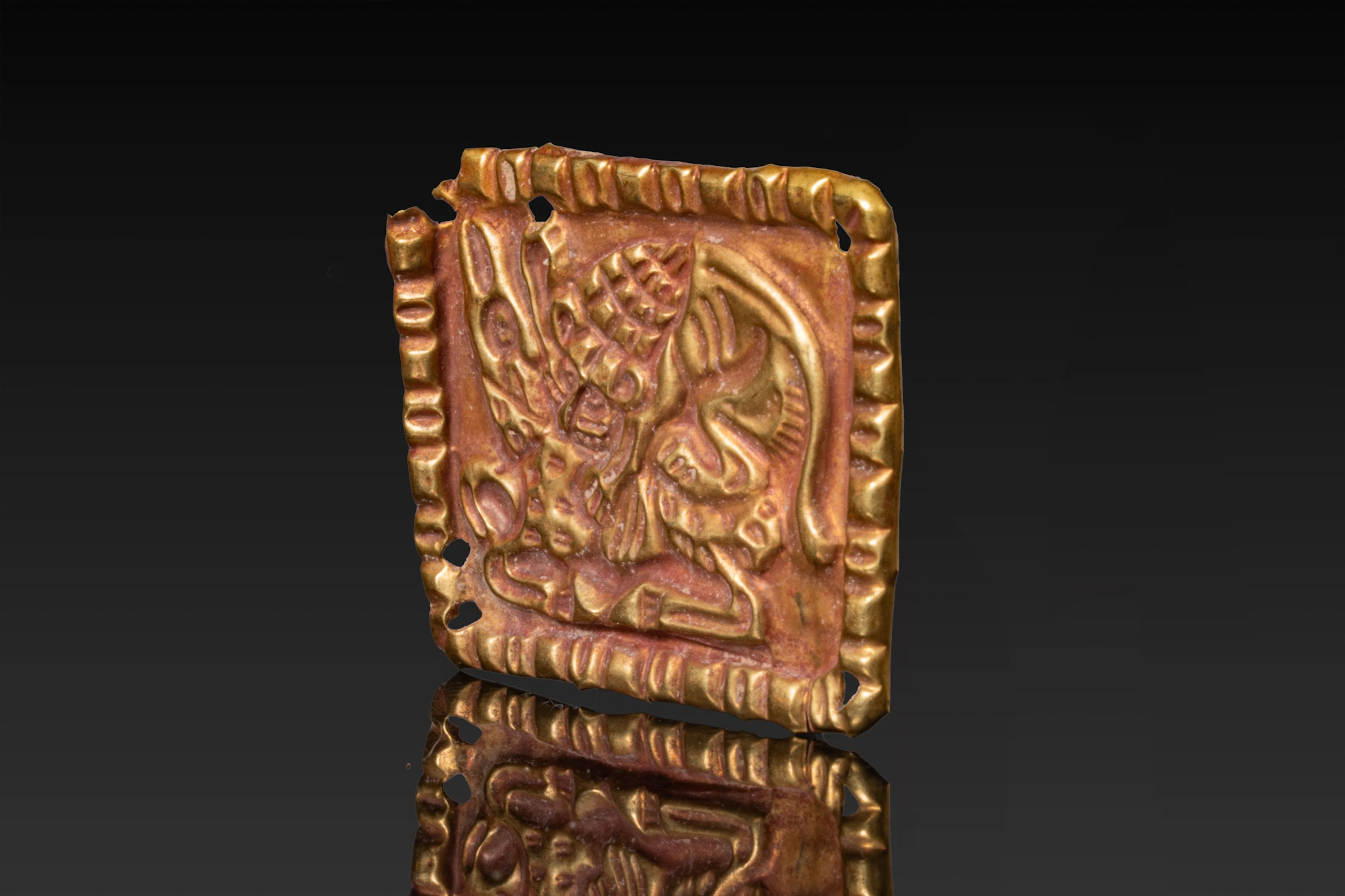 SCYTHIAN REPOUSSÉ HIGH KARAT GOLD PLAQUE WITH LION AND DEER