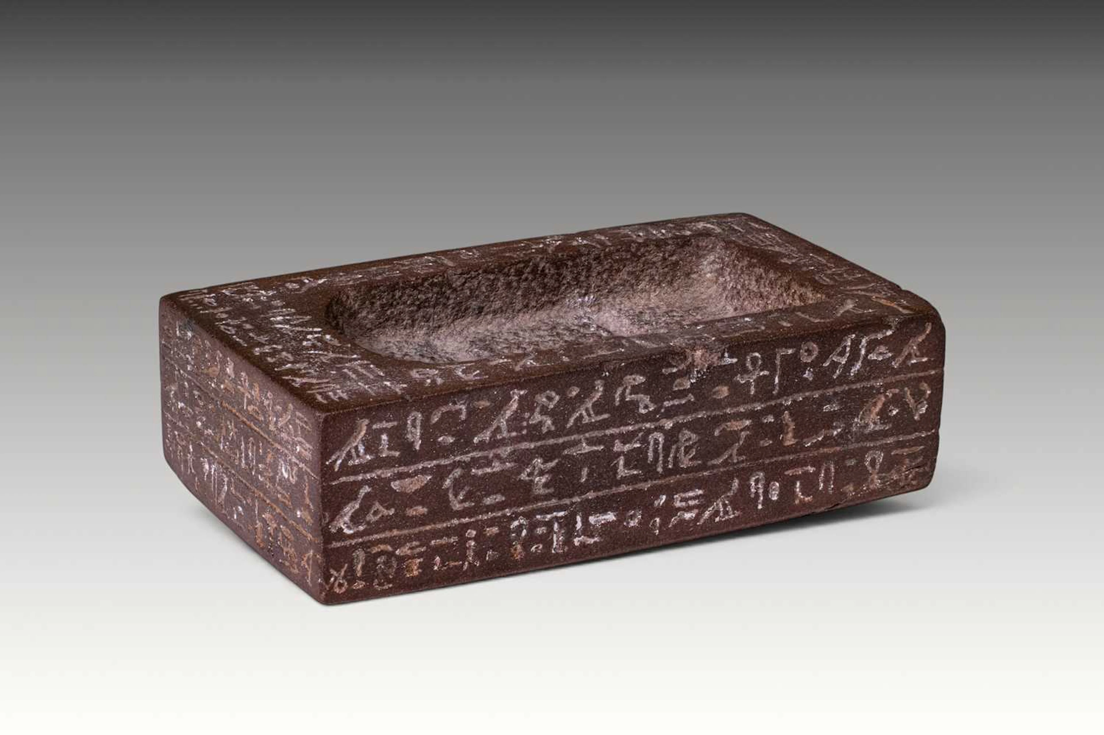 EGYPTIAN HEMATITE STATUE BASE WITH HIEROGLYPHIC INSCRIPTION - EX CHRISTIE'S