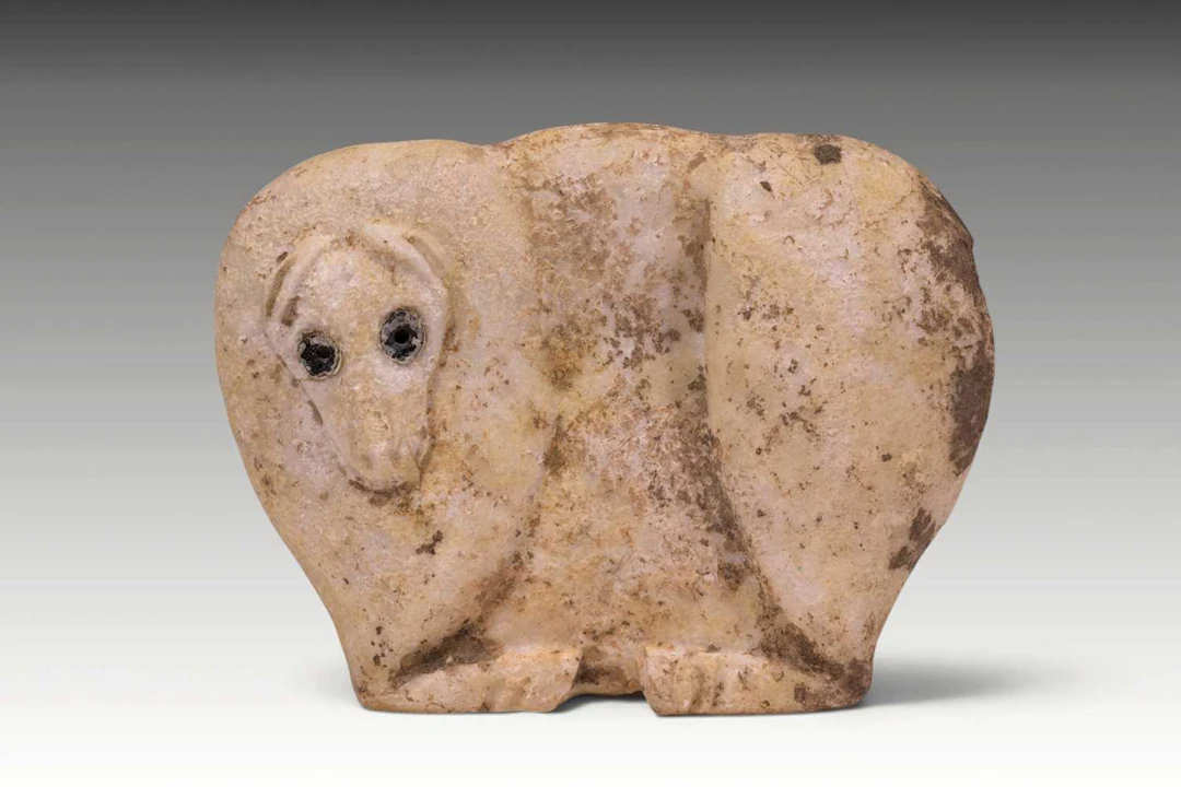 LARGE SUMERIAN MARBLE IDOL OF RECUMBENT BULL