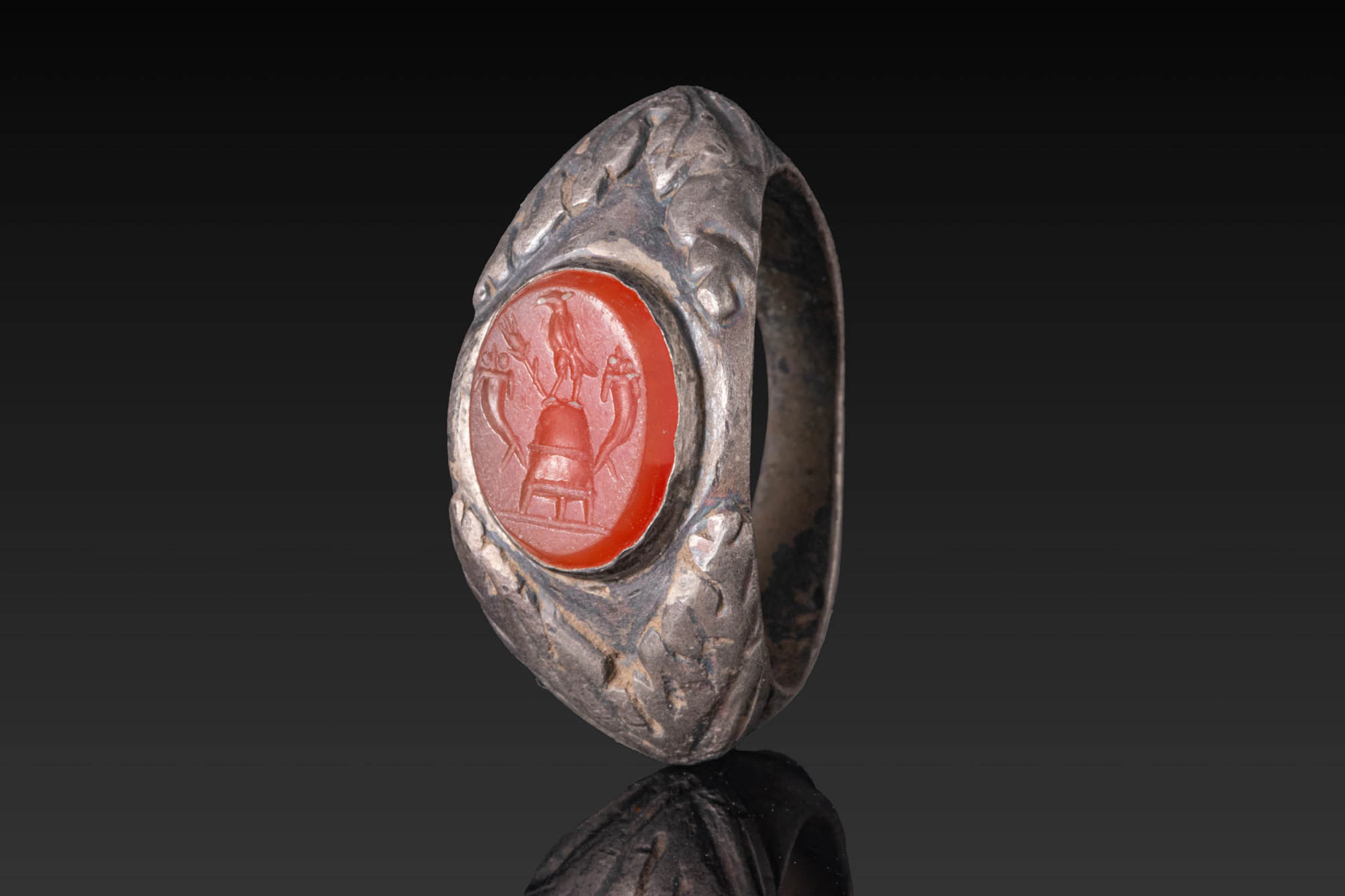 LATE ROMAN SILVER RING WITH CARNELIAN INTAGLIO DEPICTING MAGICAL SYMBOLS