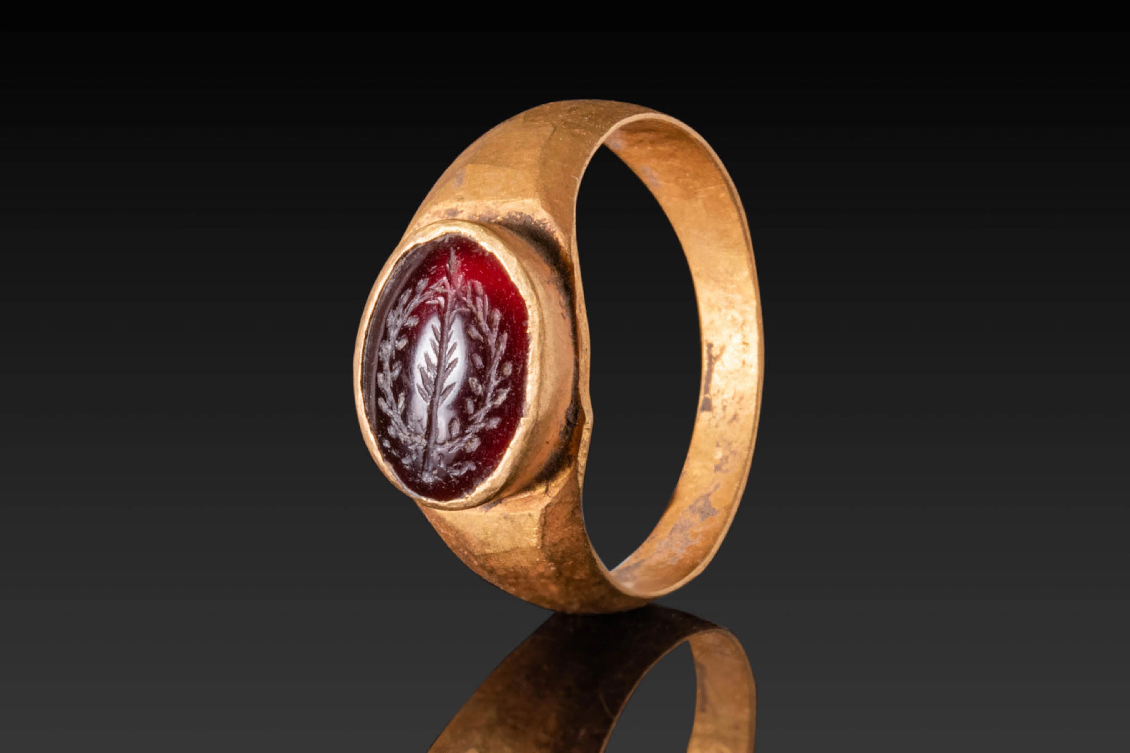 BYZANTINE HIGH KARAT GOLD RING WITH GARNET INTAGLIO DEPICTING A HOLY BRANCH