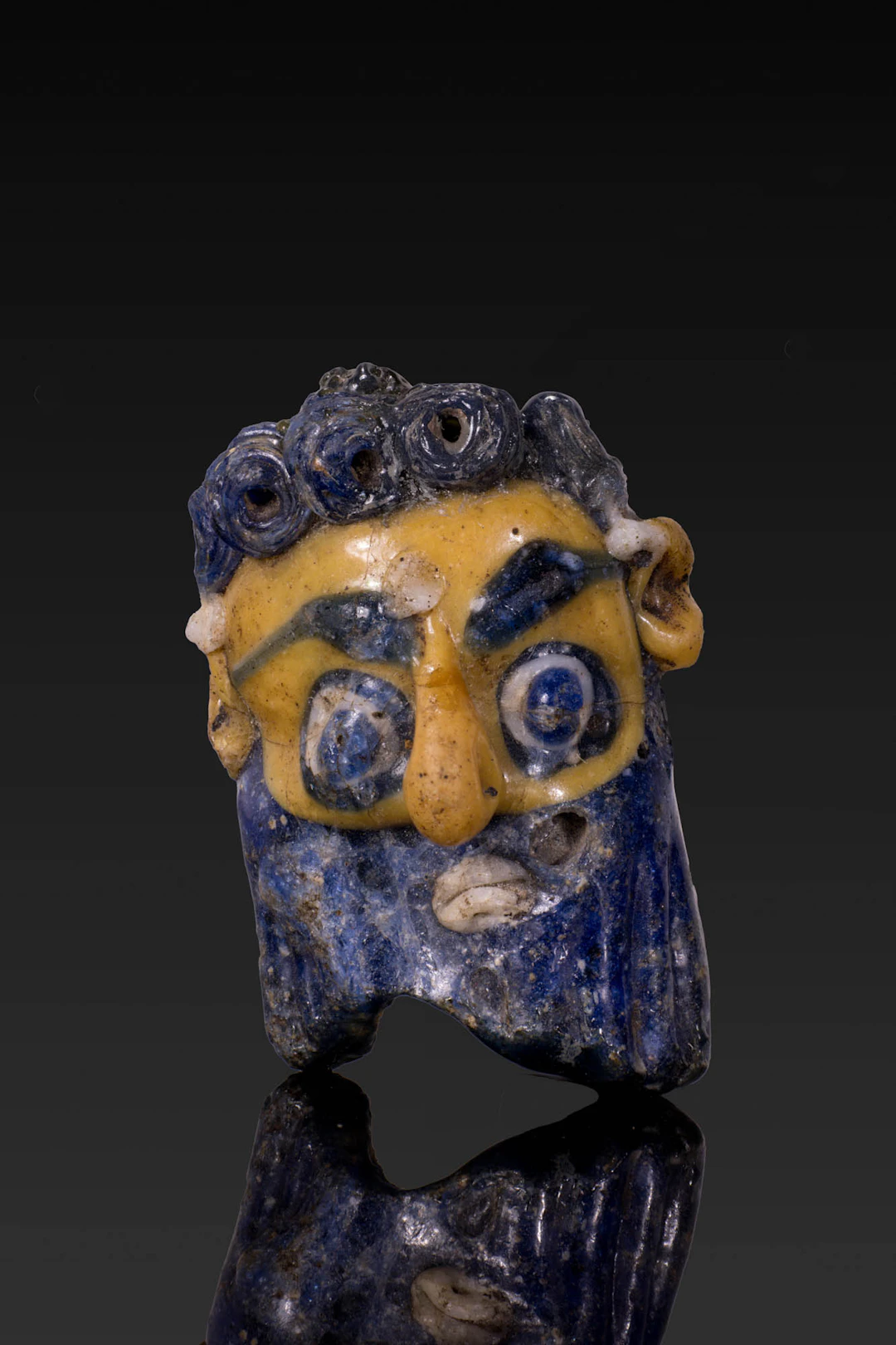 CARTHAGINIAN POLYCHROME GLASS FACE BEAD