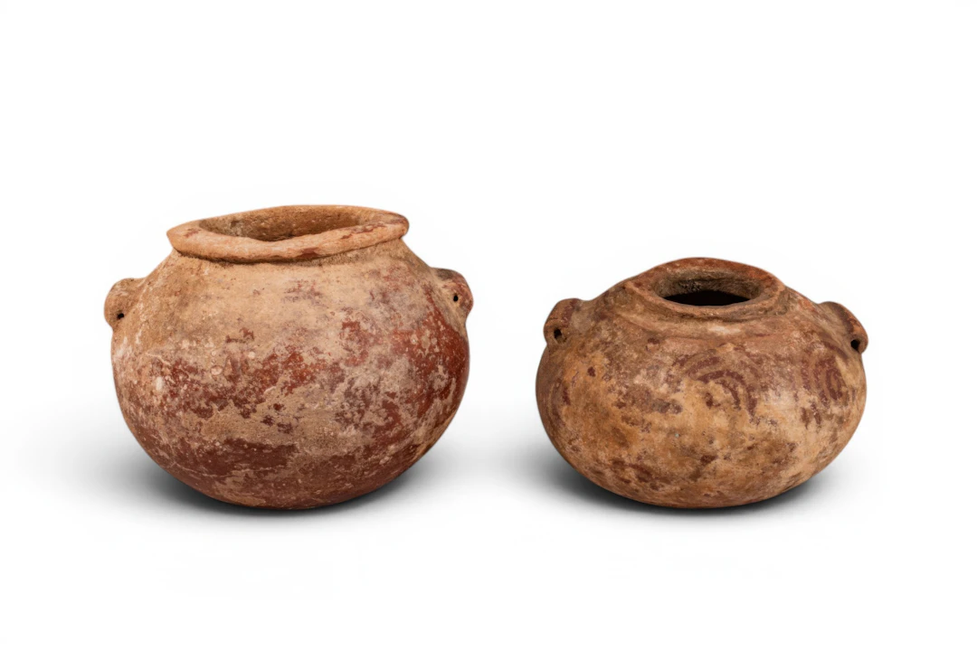 PAIR OF EGYPTIAN PREDYNASTIC TERRACOTTA JARS WITH RED ENGOBE GEOMETRIC MOTIFS