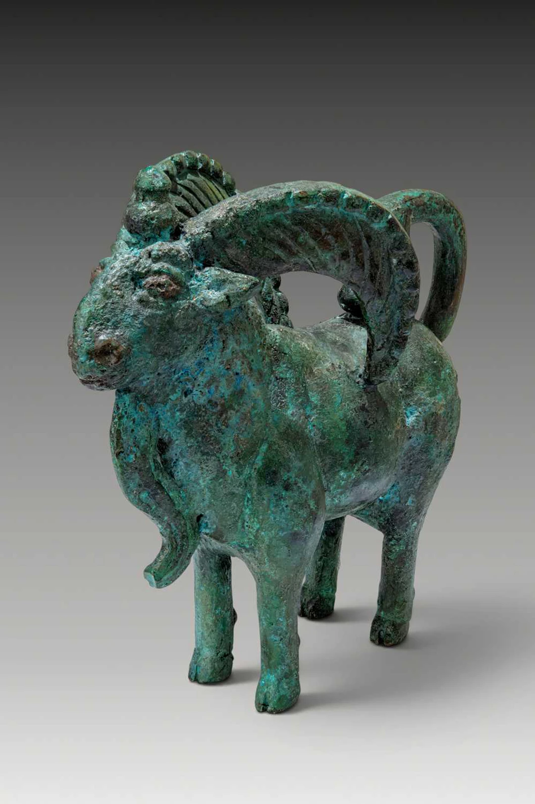 URARTIAN BRONZE RAM FIGURINE WITH SERPENT-PROTOME TAIL