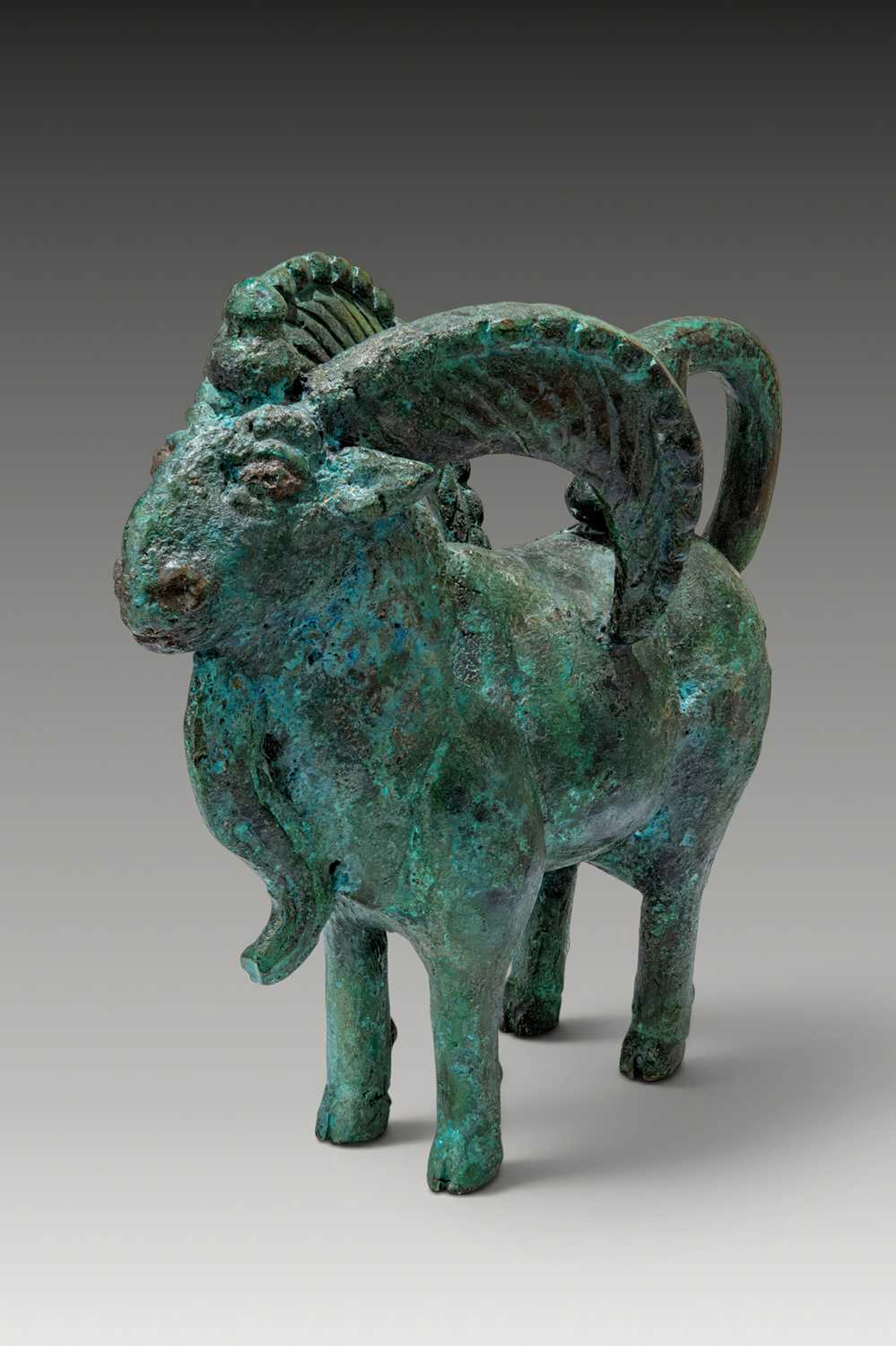 URARTIAN BRONZE RAM FIGURINE WITH SERPENT-PROTOME TAIL