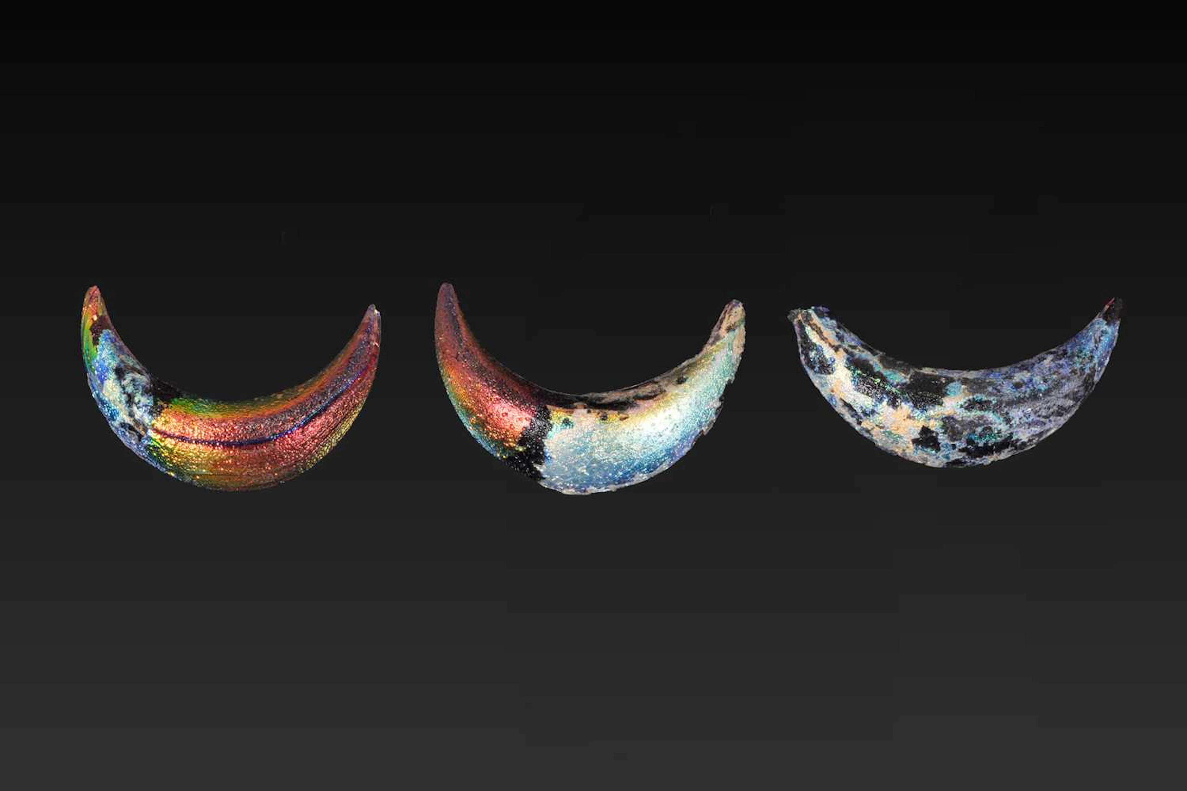 COLLECTION OF THREE GREEK IRIDESCENT GLASS LUNULA PENDANTS
