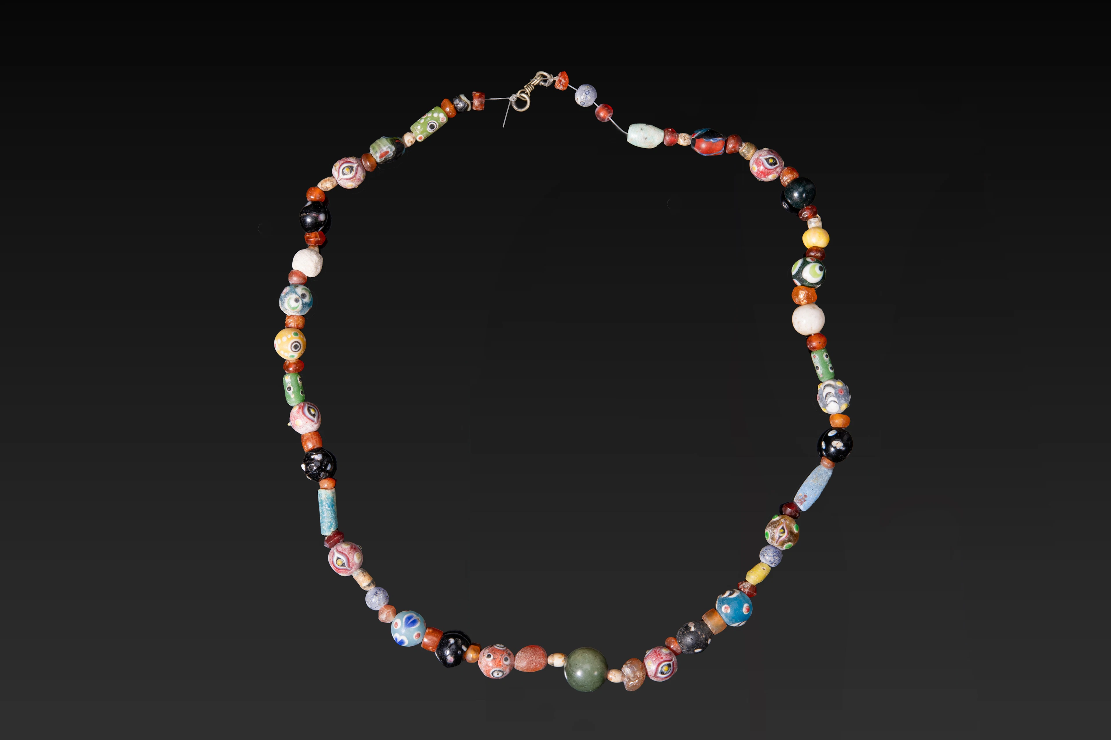 NECKLACE WITH ROMAN, GREEK AND PHOENICIAN GLASS, STONE AND FAIENCE BEADS