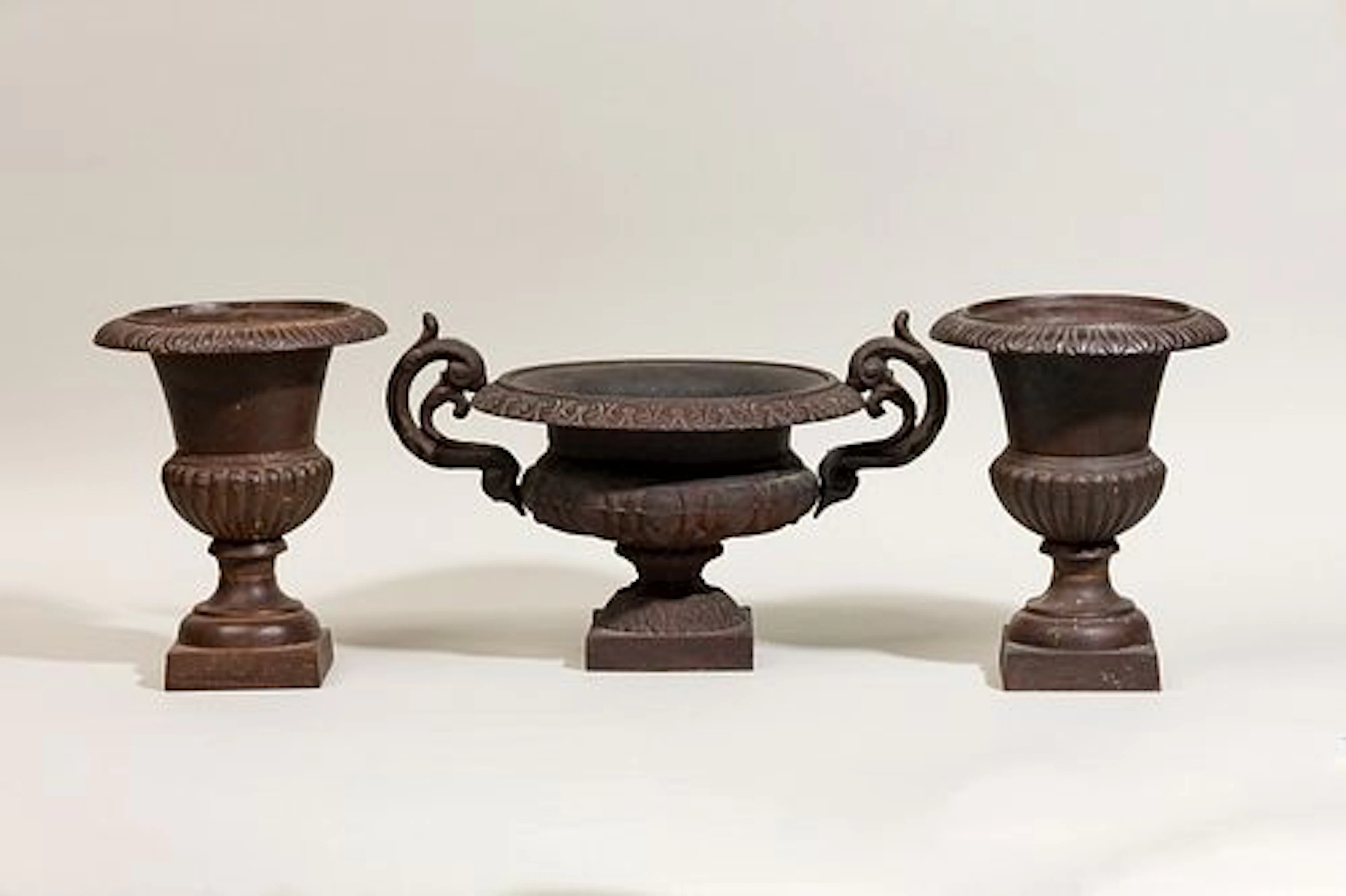 Neoclassical style cast iron garniture de cheminee with baluster vases