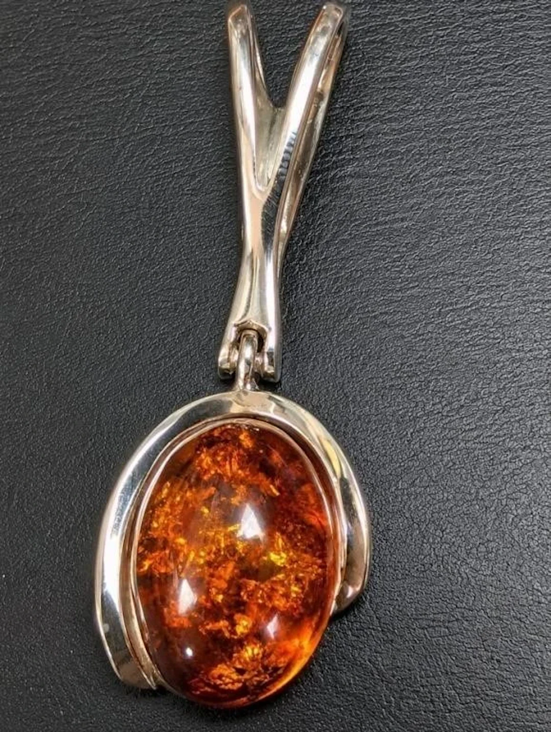 $400, silver(6.65g), amber pendant, retail value