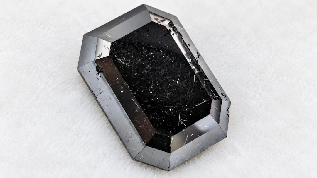 $2400, black diamond (5.9ct)gemstone, retail value
