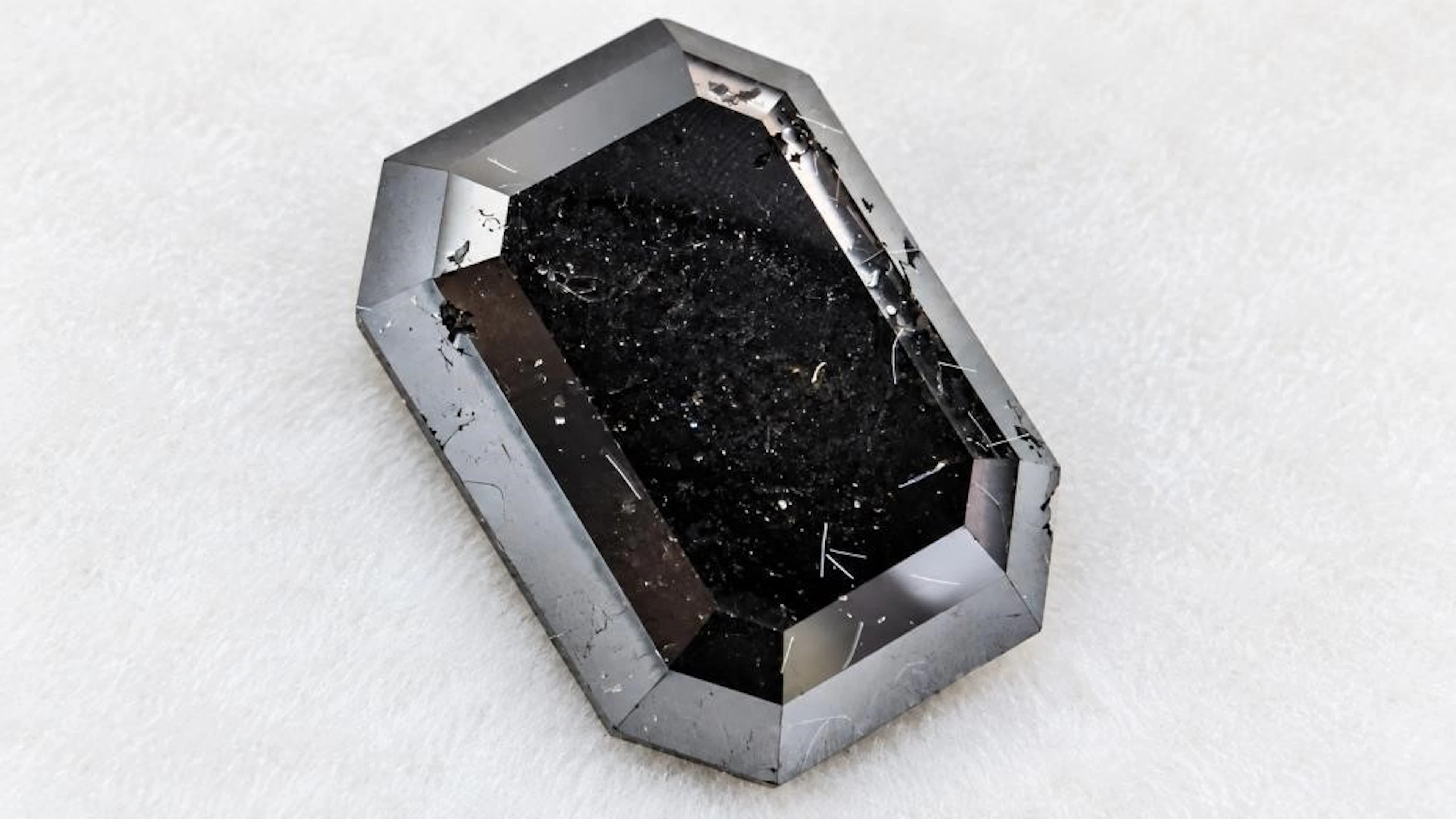 $2400, black diamond (5.9ct)gemstone, retail value
