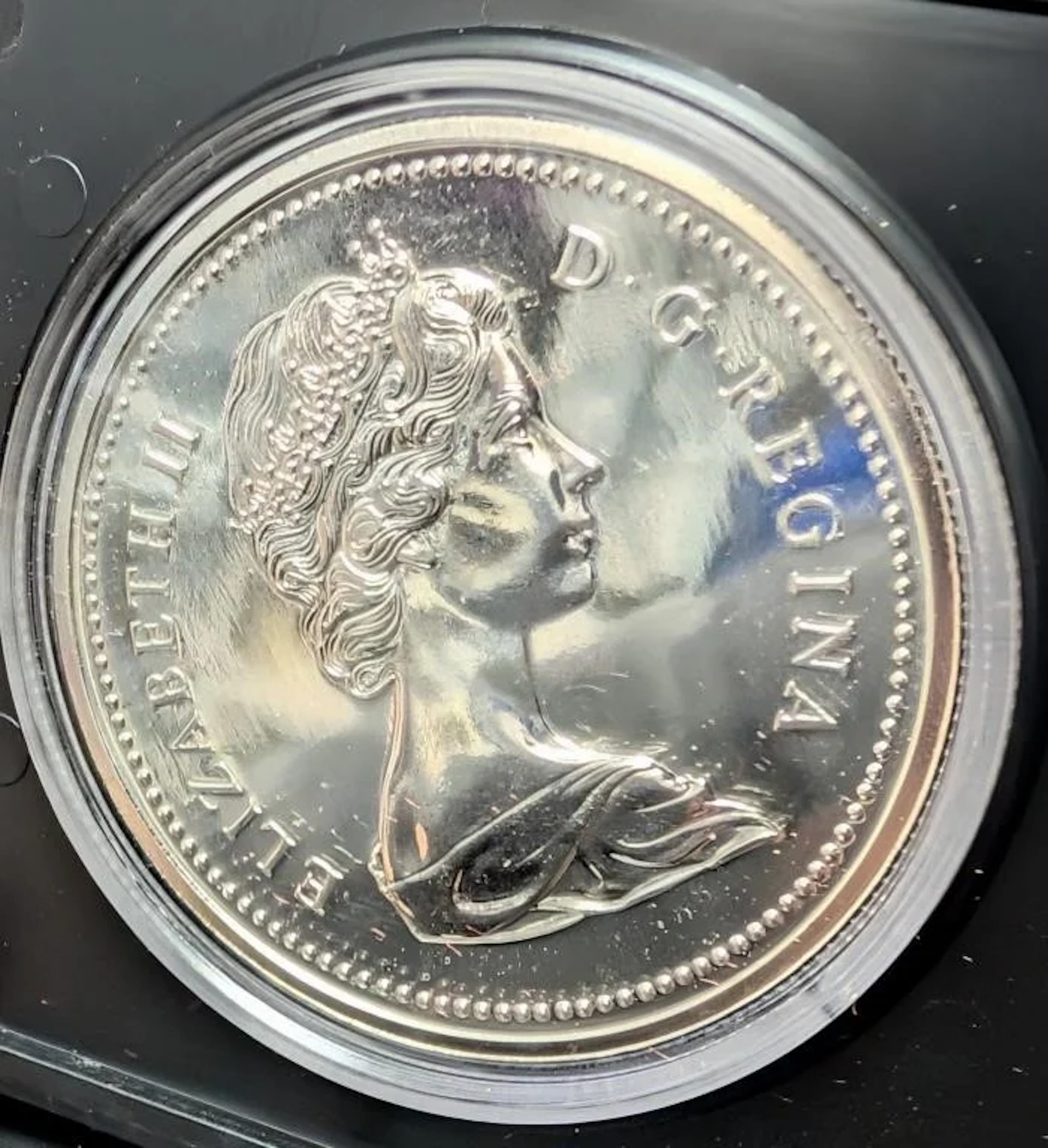 ., Silver (23.3g) proof dollar coin, retail value