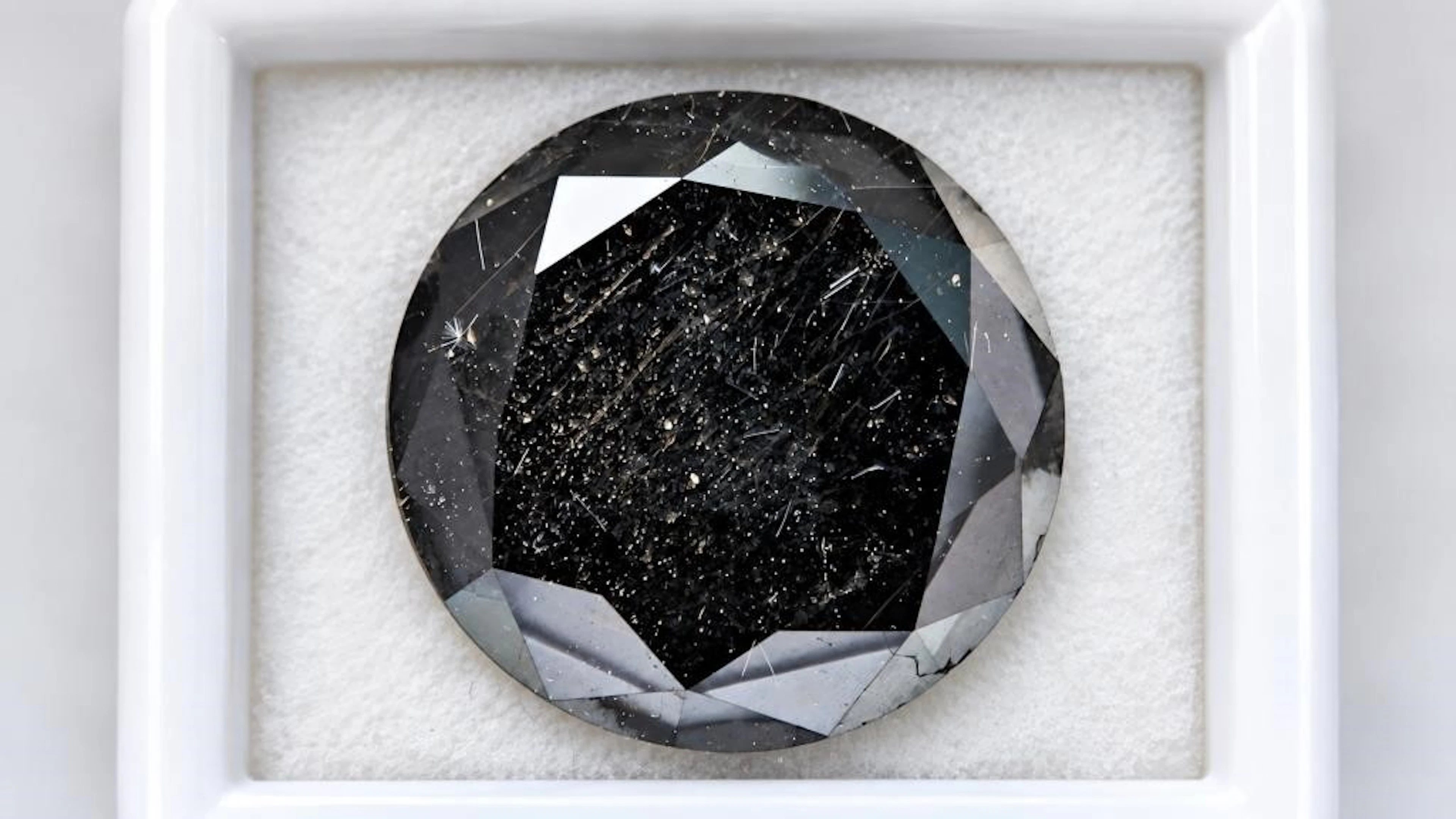 $2400, black diamond (5.9ct)gemstone, retail value