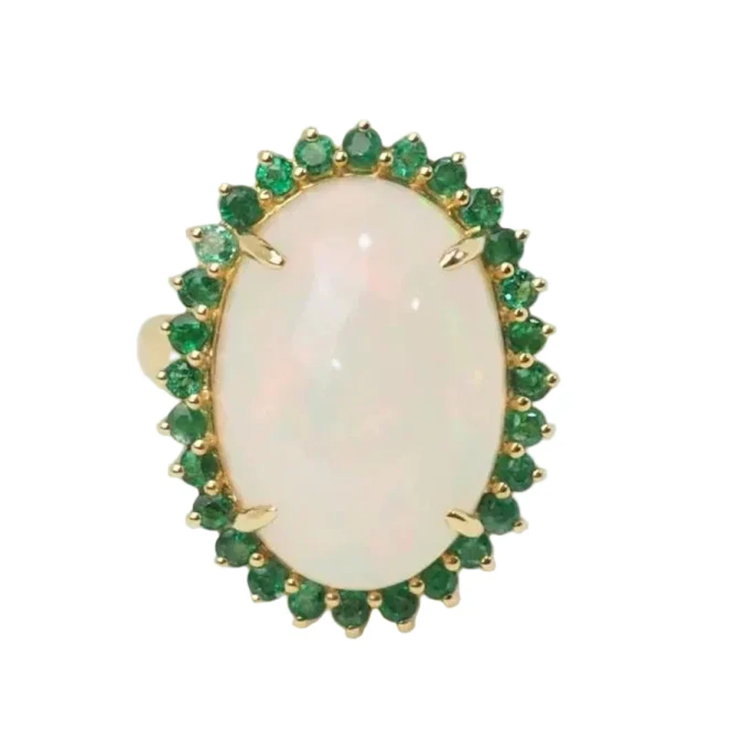 Oval ring in yellow gold, cabochon opal and emeralds