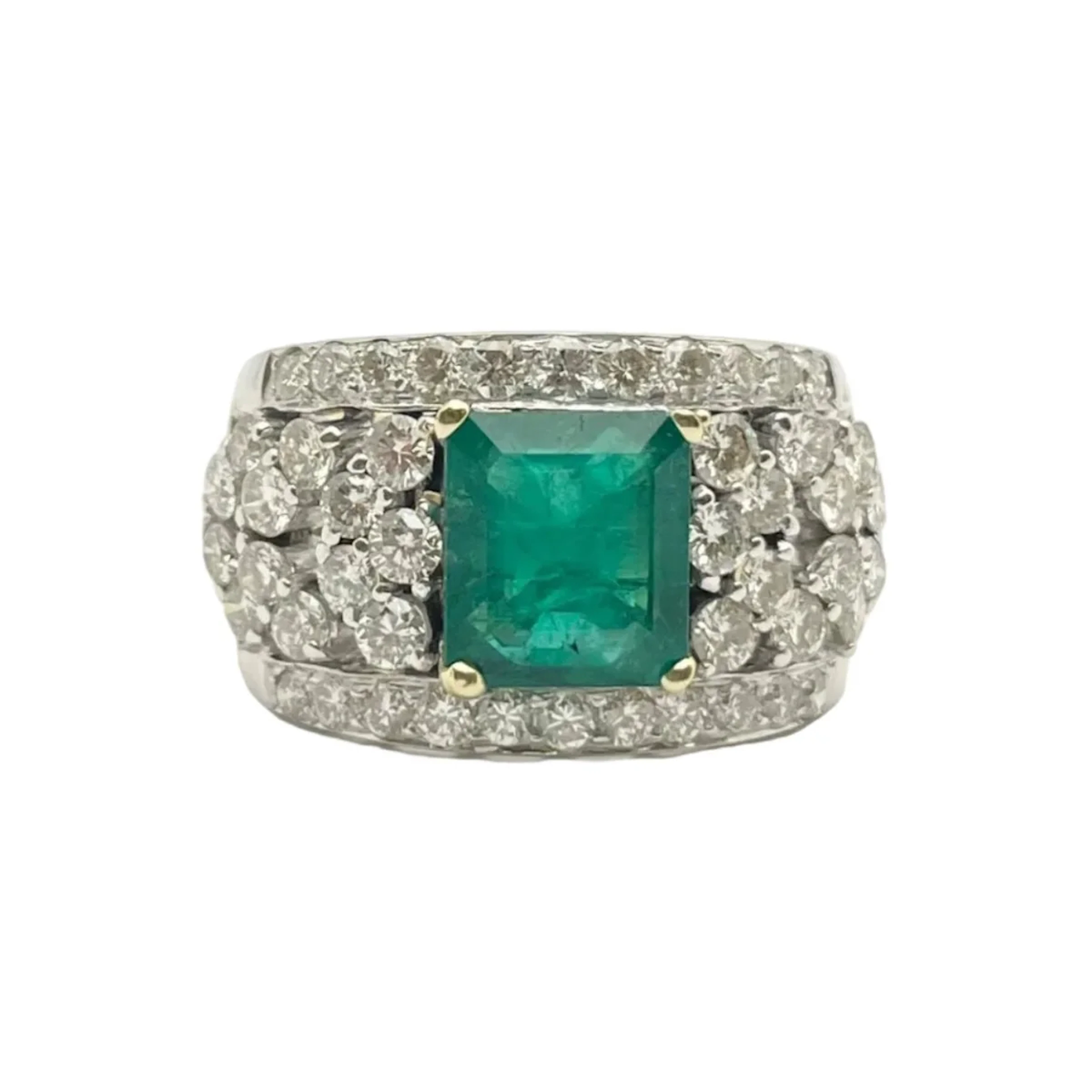 Ring in white gold, yellow gold, emerald and diamonds.