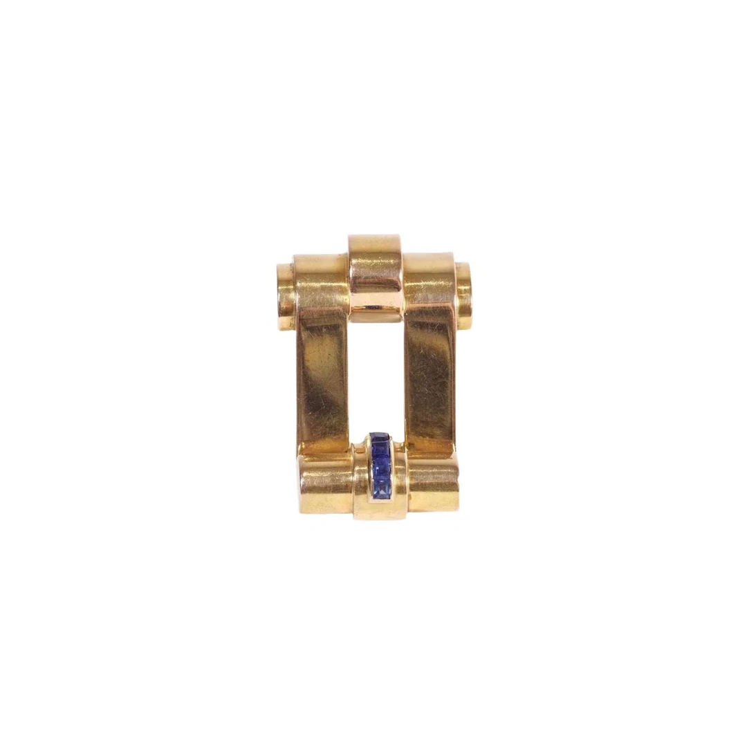 Lapel clip in yellow gold and sapphires