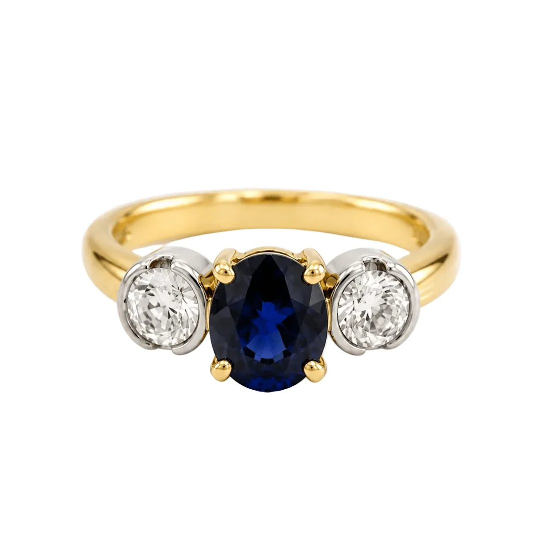 Trilogy Ring in white gold, yellow gold, sapphire, and diamonds
