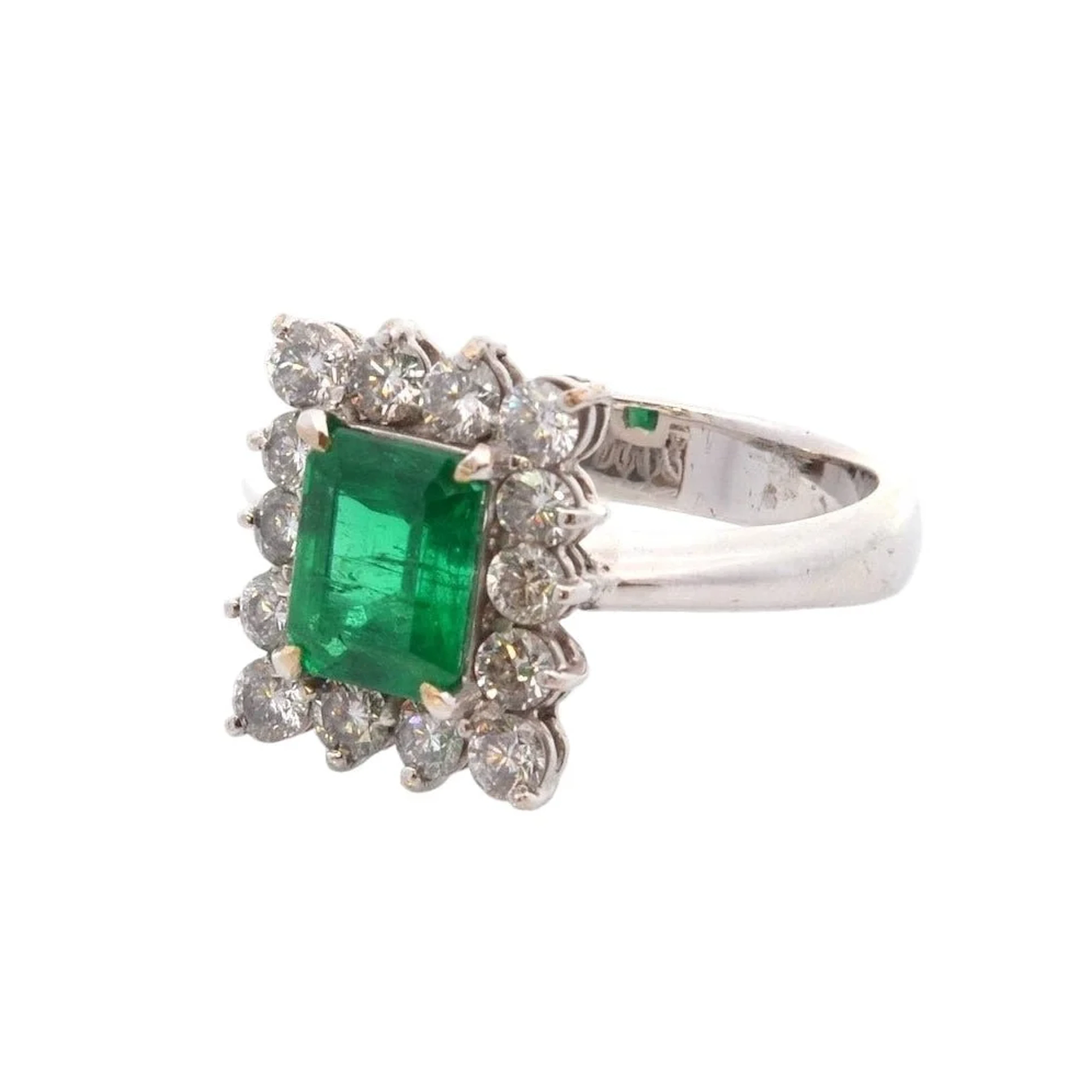 Entourage ring in platinum, emerald, and diamonds