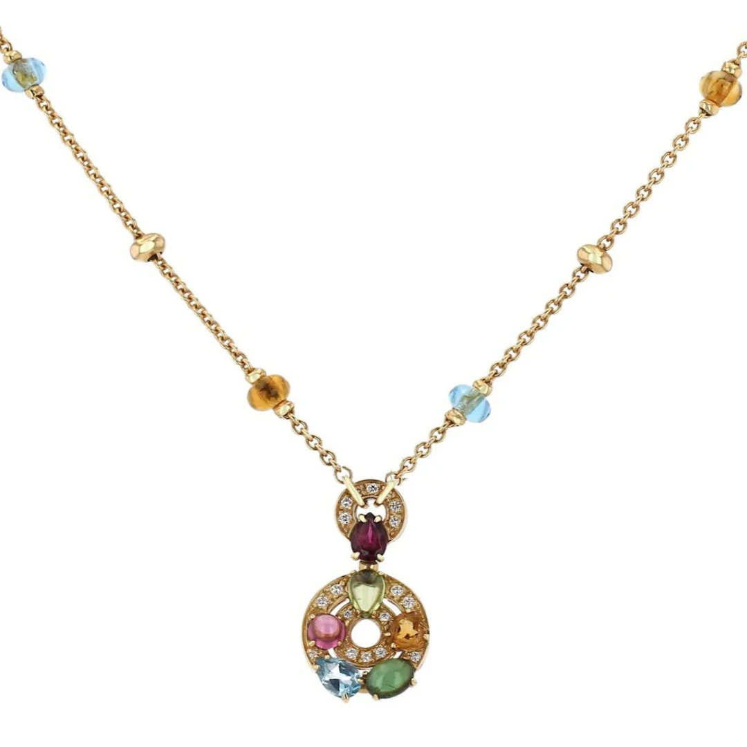 BULGARI “Astrale” pendant necklace in yellow gold, garnet, topaz