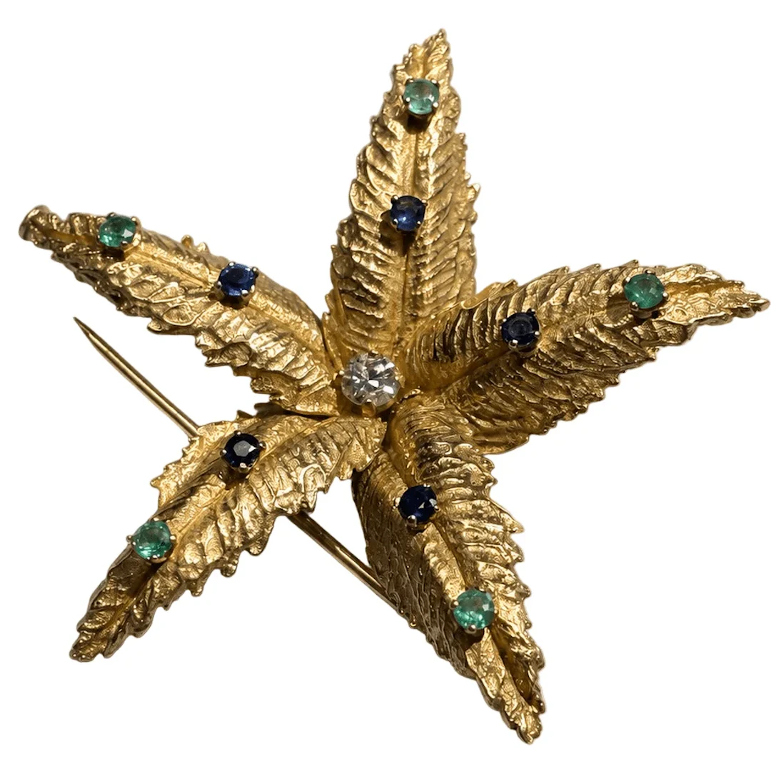 BOUCHERON brooch in yellow gold, emeralds, sapphires, and diamonds