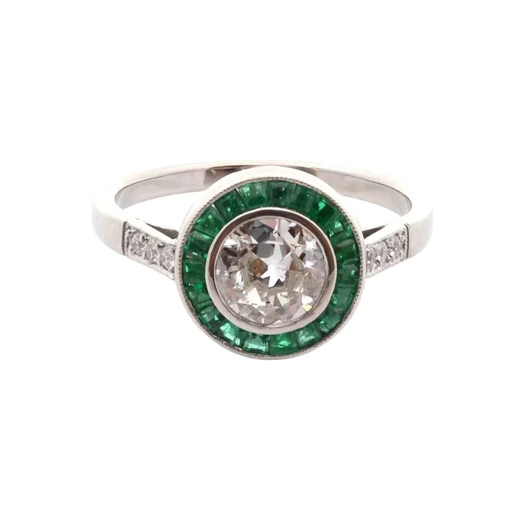Platinum, emerald and diamond surround ring
