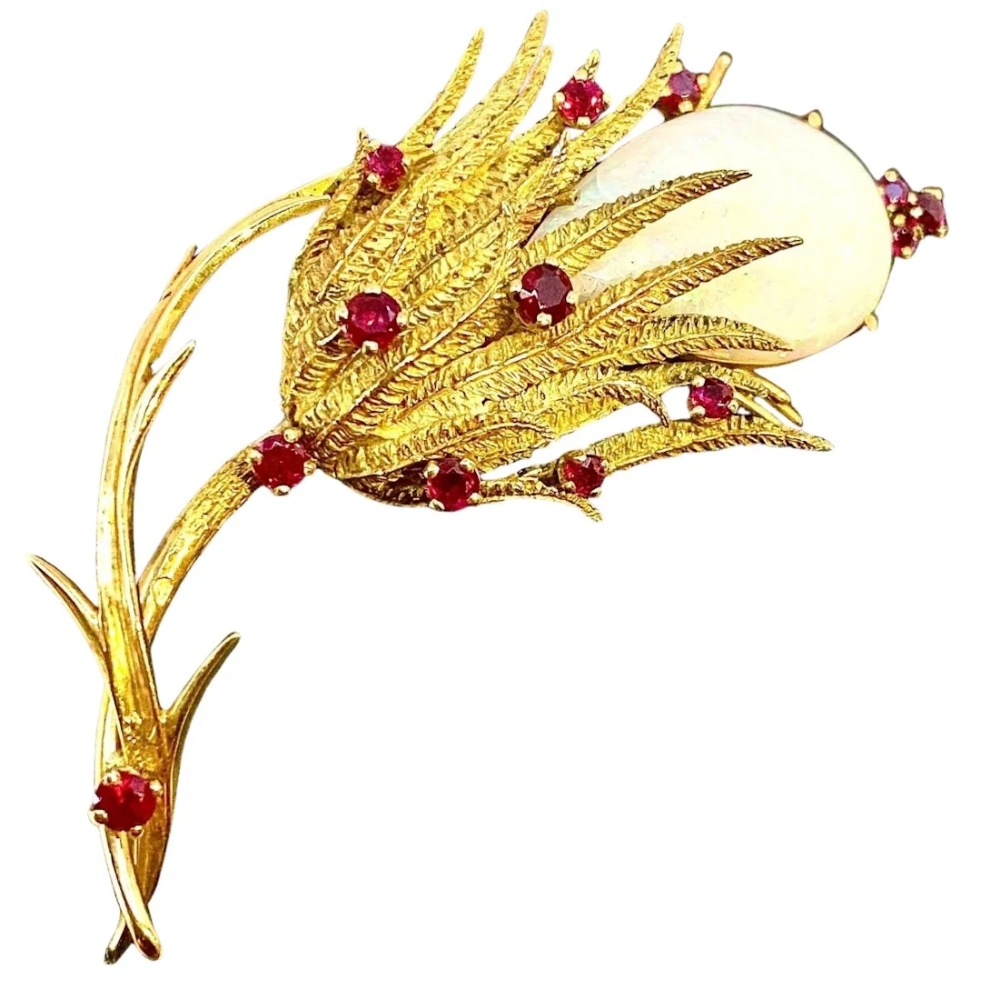 18-karat gold brooch decorated with a large opal and 13 rubies, circa 1960