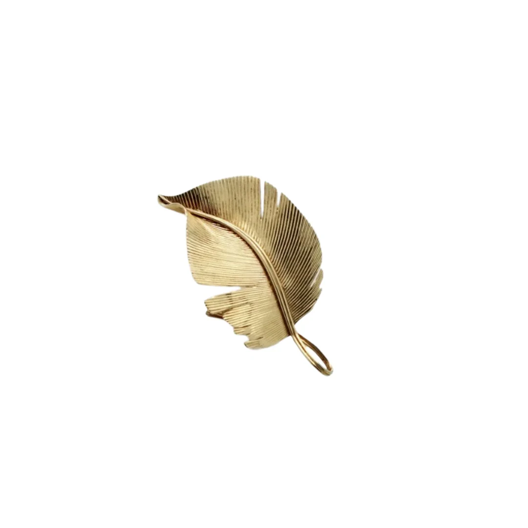 HERMÈS “Feather” brooch in yellow gold