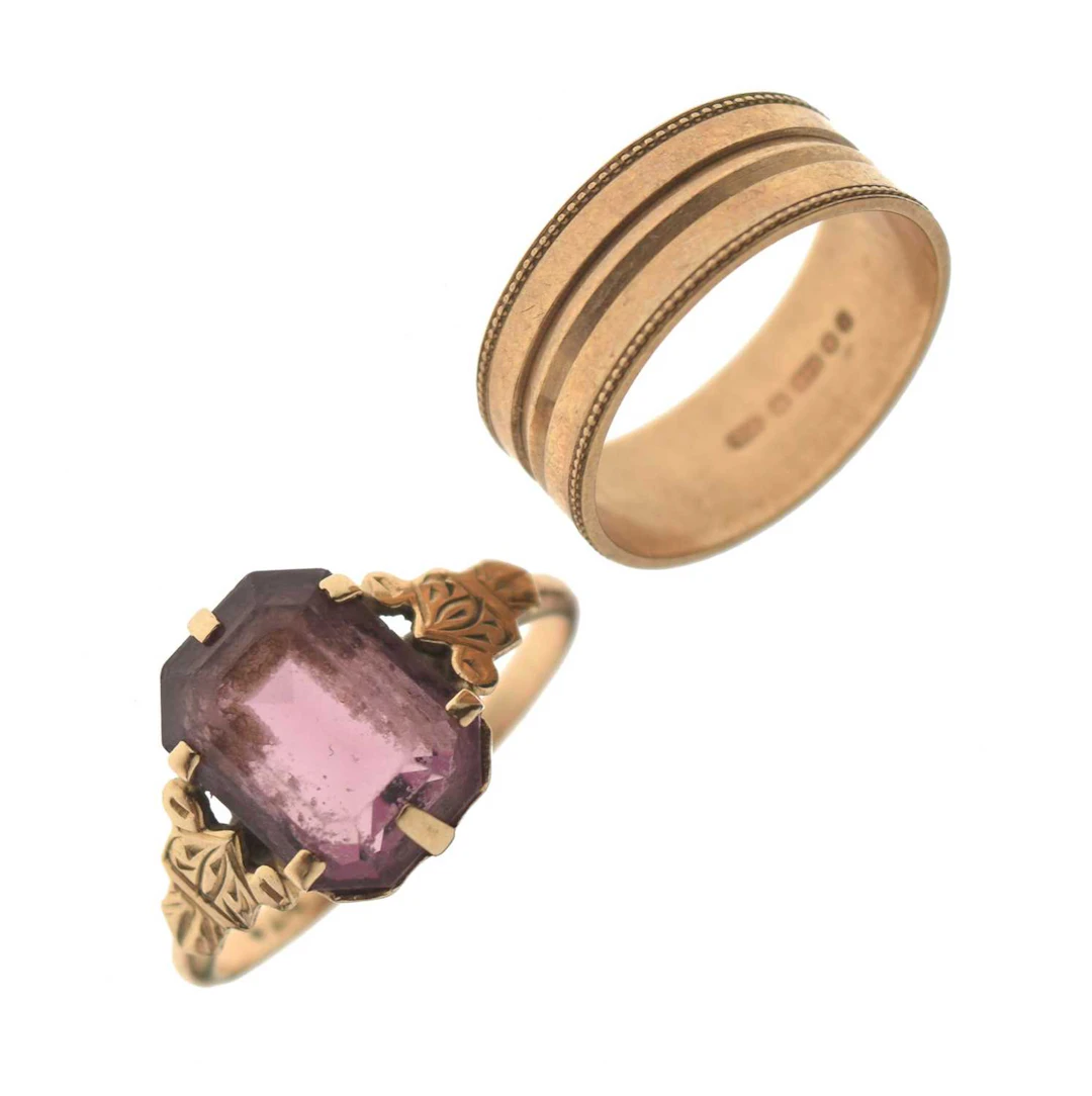 9ct gold patterned wedding band and a purple paste yellow metal dress ring (2)