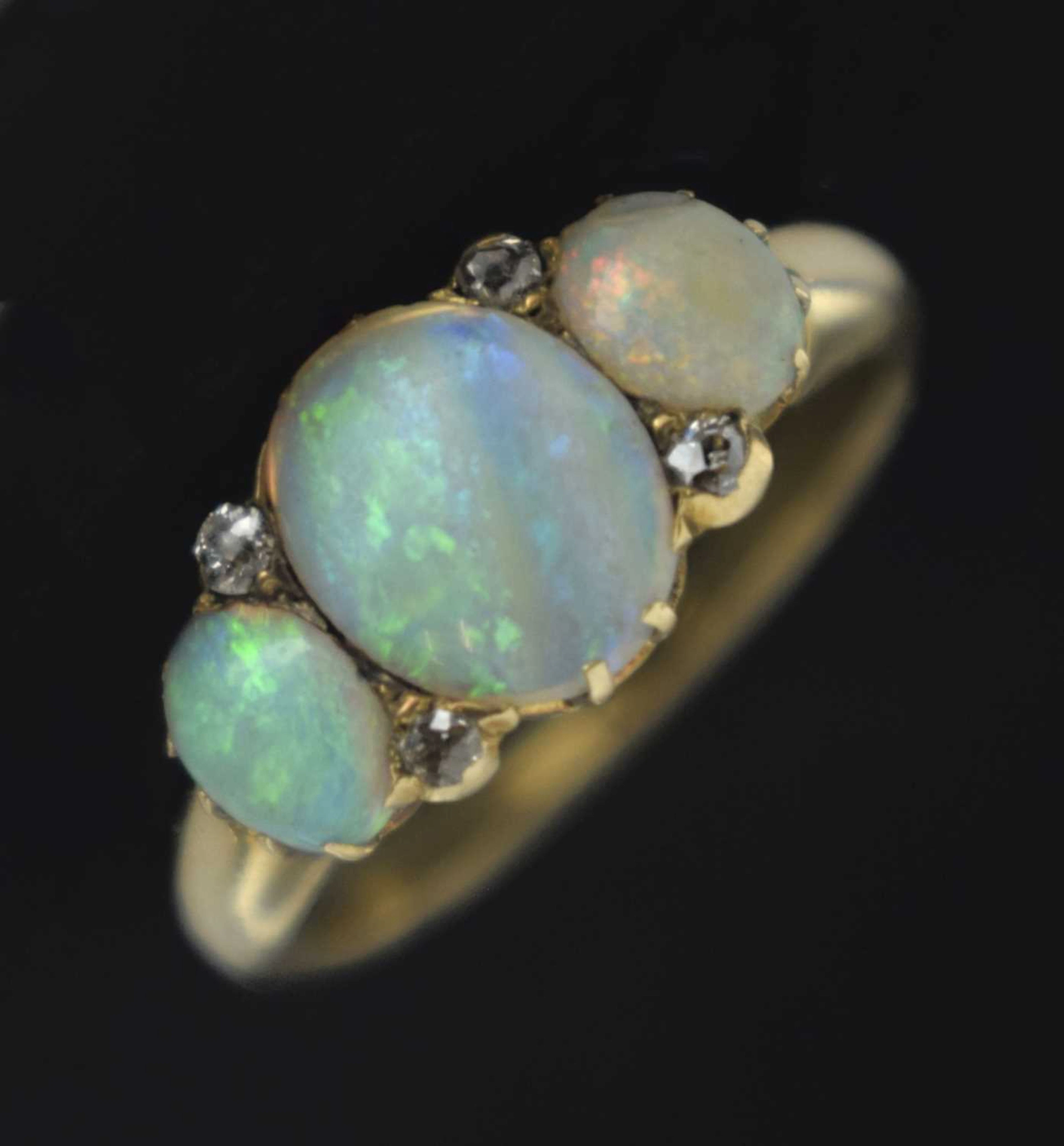Opal three stone unmarked yellow metal ring