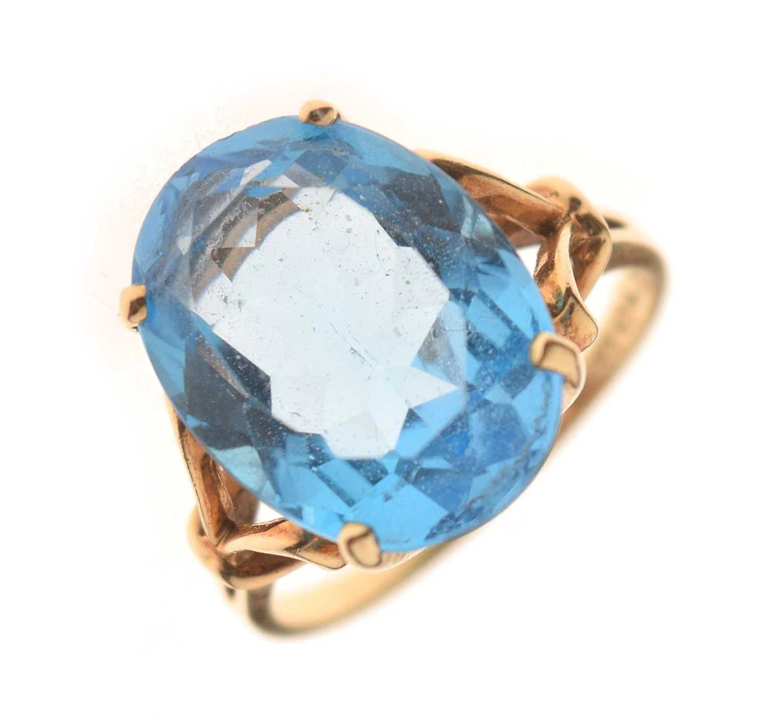 Blue topaz yellow metal dress ring