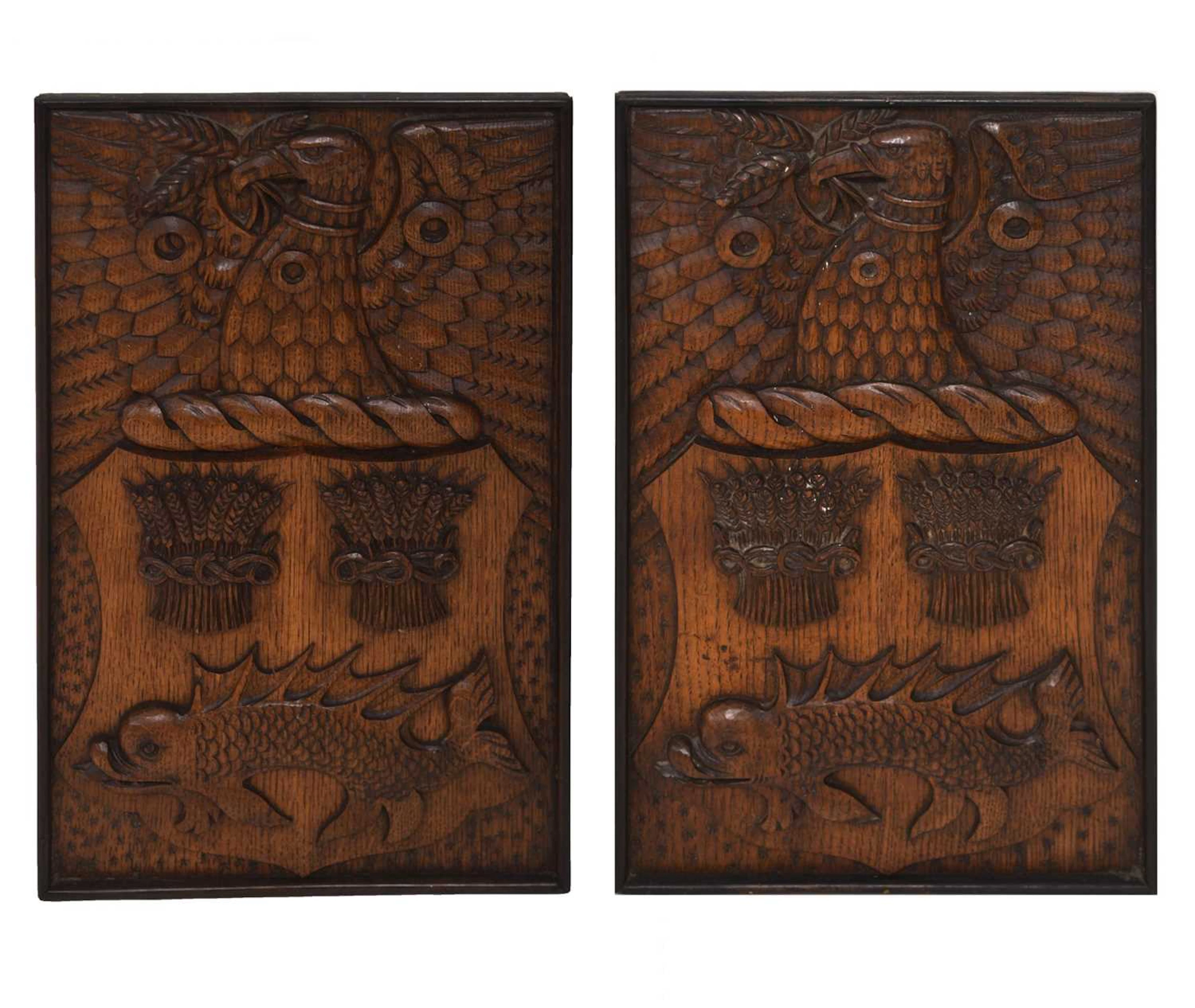 Pair of early 20th century carved oak armorial panels