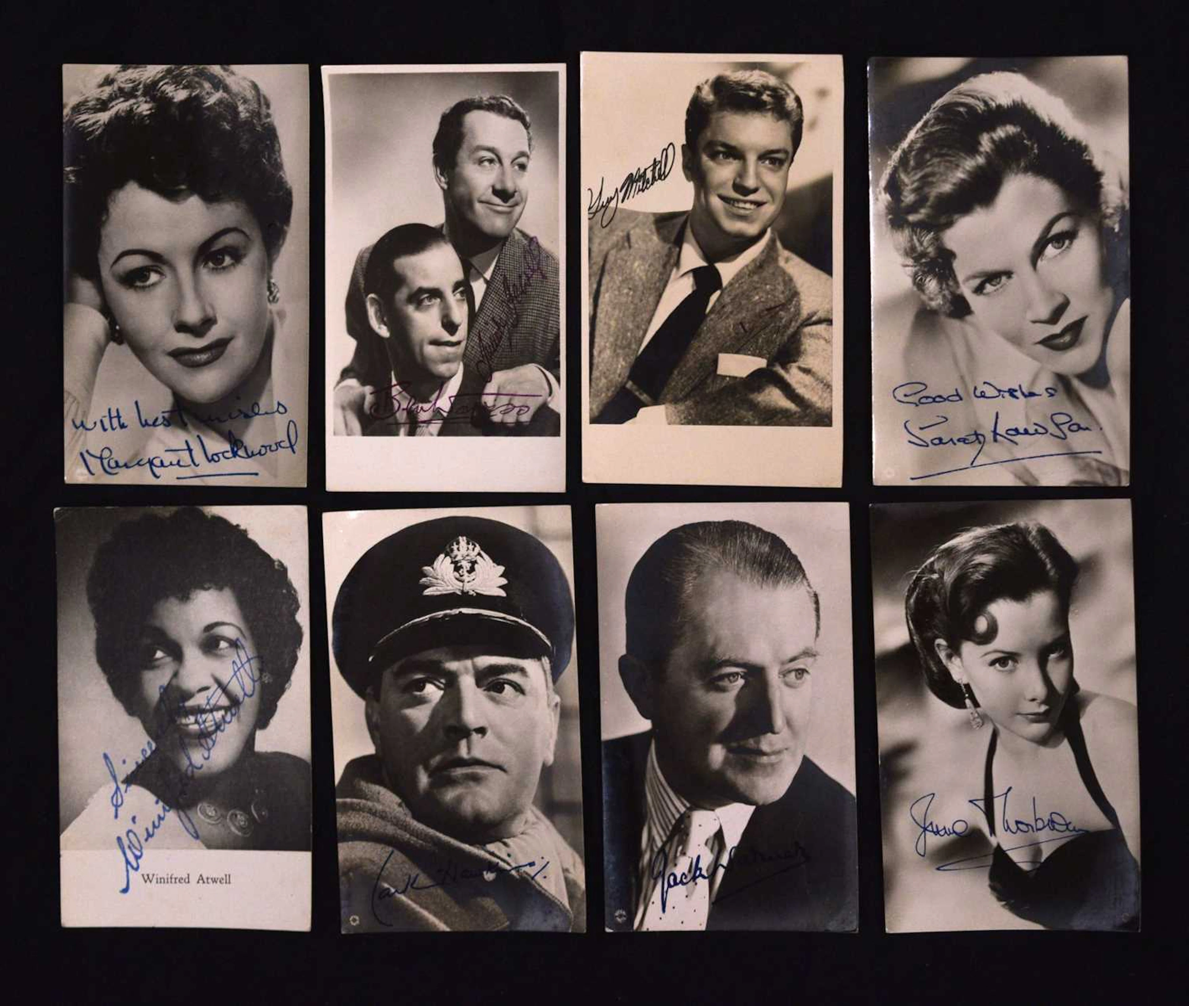 Collection of autographs and portrait photographs featuring entertainers