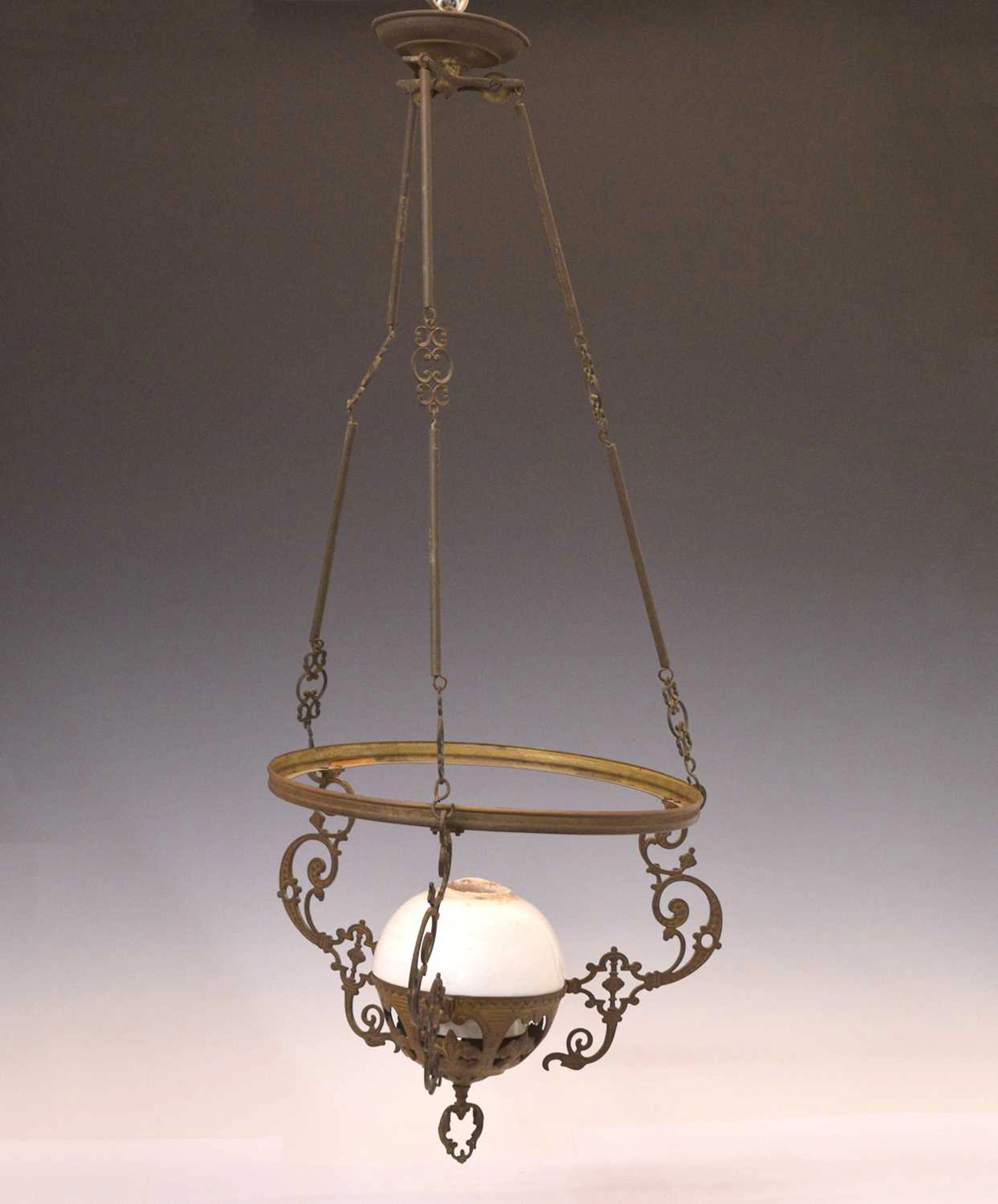 Early 20th century gilt metal and white glass 'stable' lamp