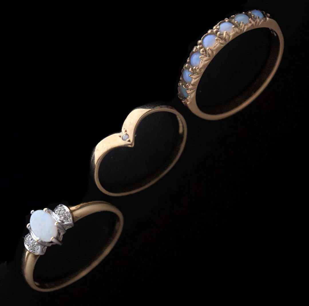 Two opal dress rings and a wishbone ring (3)