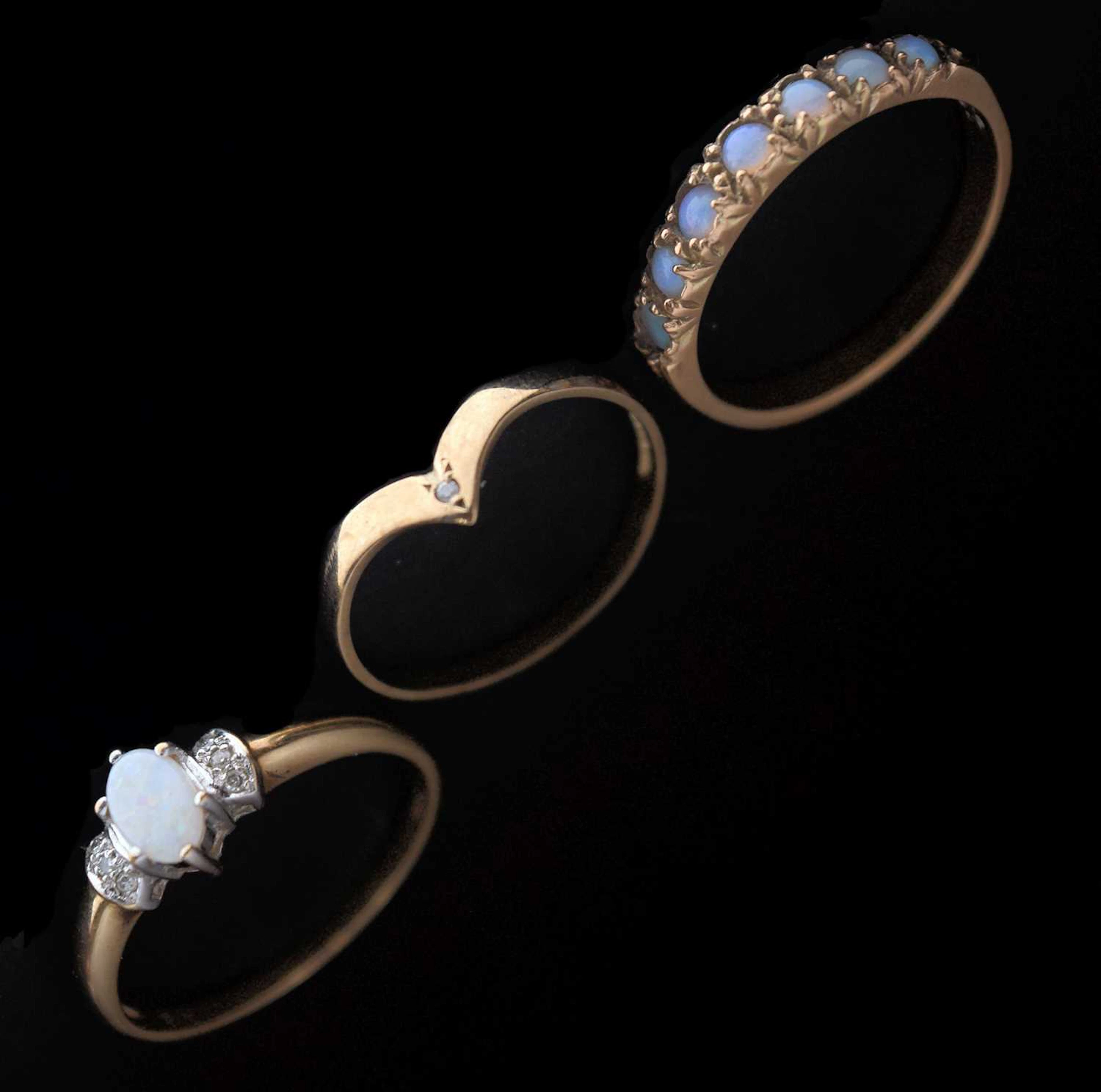 Two opal dress rings and a wishbone ring (3)