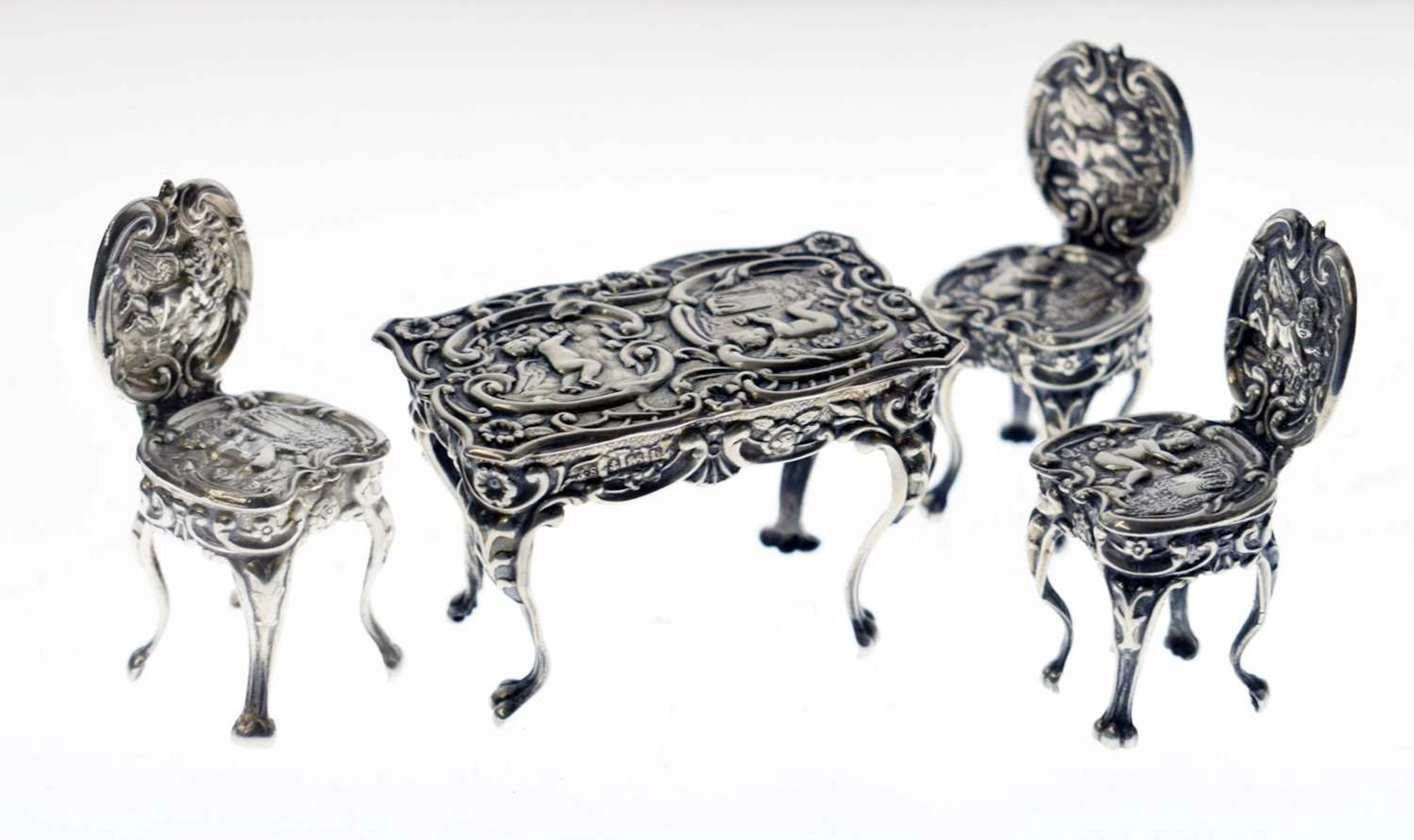 Edward VII silver miniature table and a pair of chairs, and one Elizabeth